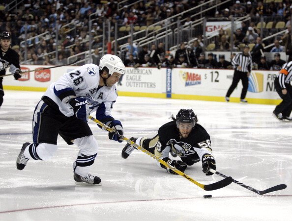 PITTSBURGH - NOVEMBER 12:  Martin St. Louis #26 of the Tampa Bay Lightning handles the puck around Kris Letang #58 of the Pittsburgh Penguins at Consol Energy Center on November 12, 2010 in Pittsburgh, Pennsylvania.  (Photo by Justin K. Aller/Getty Images