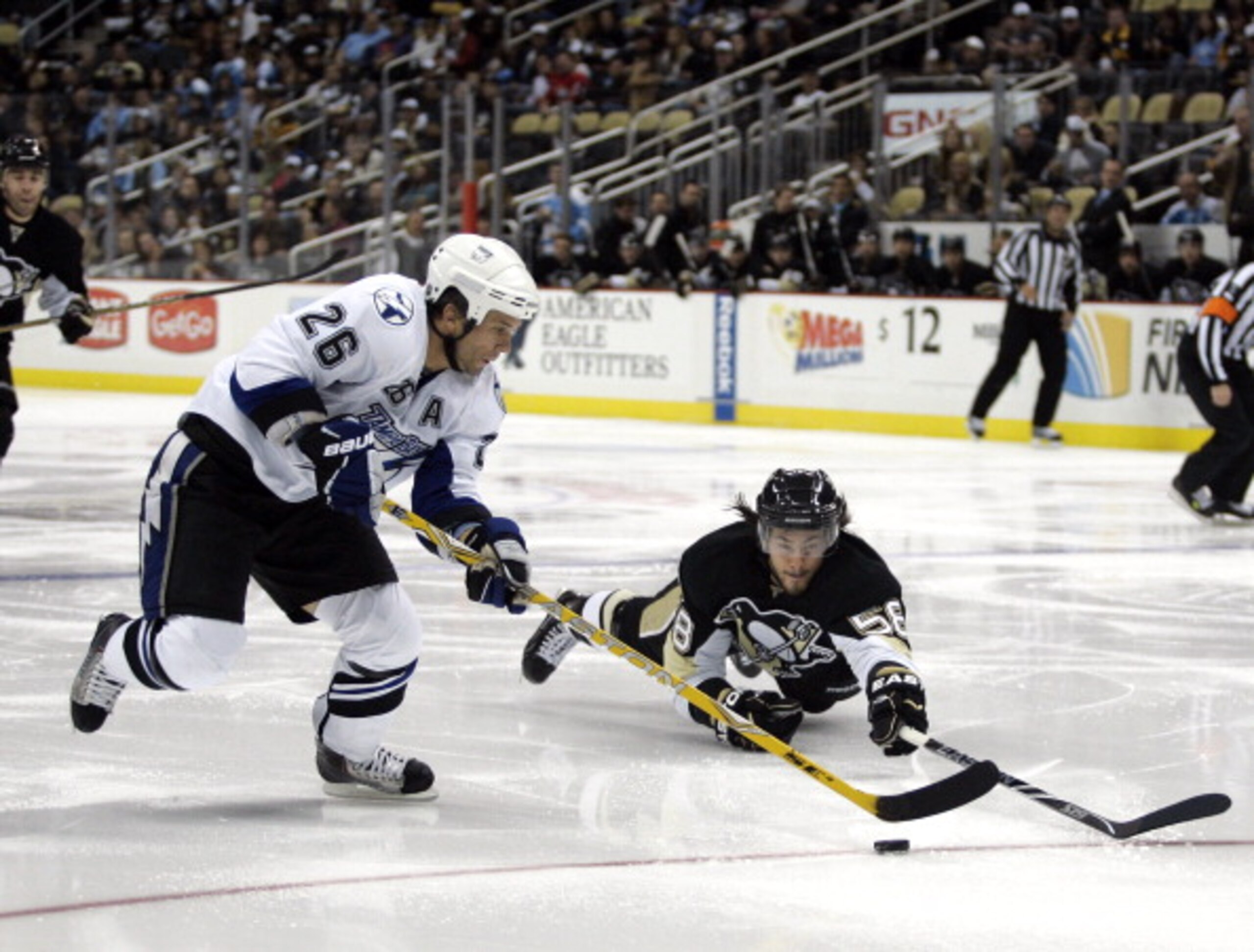 PITTSBURGH - NOVEMBER 12:  Martin St. Louis #26 of the Tampa Bay Lightning handles the puck around Kris Letang #58 of the Pittsburgh Penguins at Consol Energy Center on November 12, 2010 in Pittsburgh, Pennsylvania.  (Photo by Justin K. Aller/Getty Images