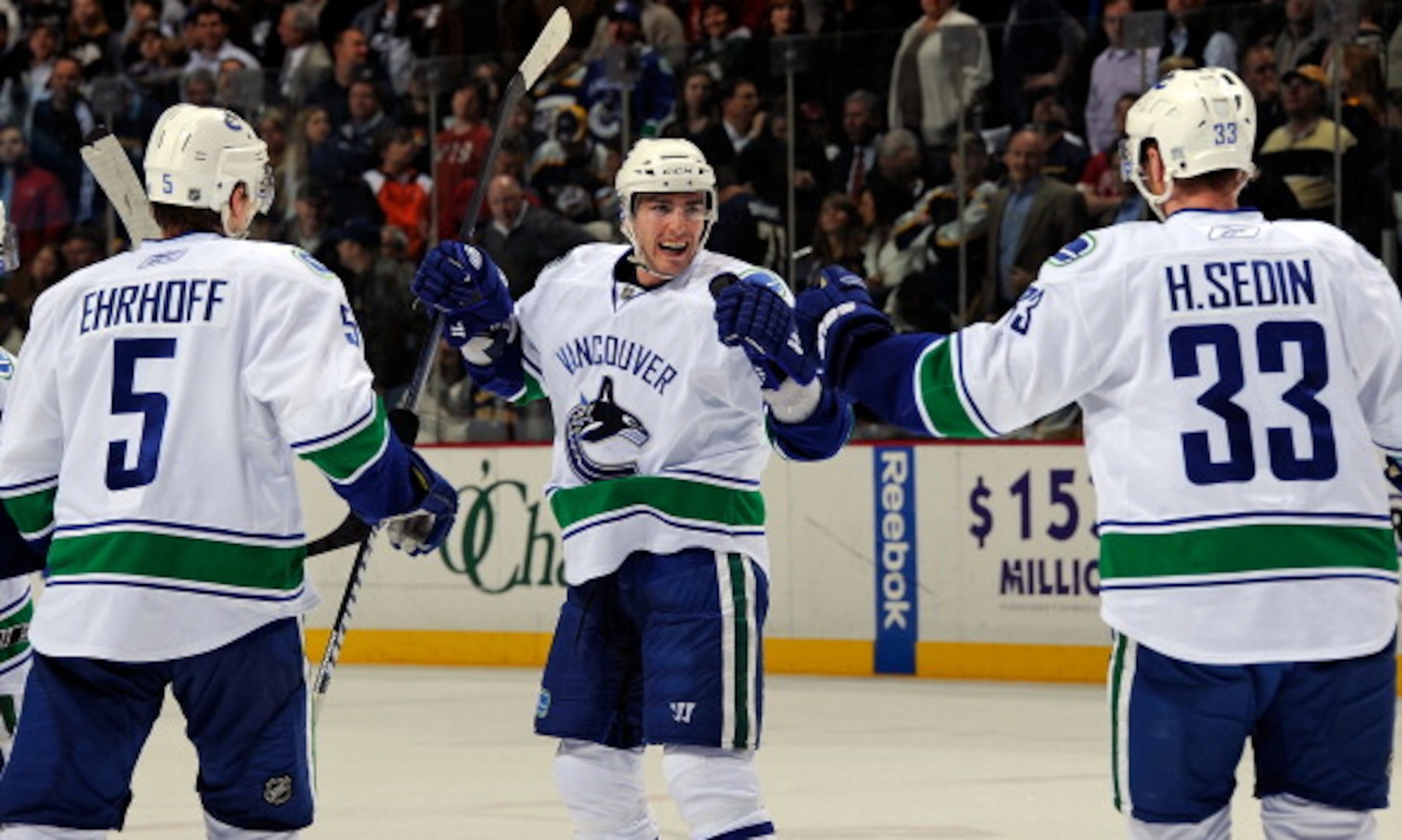 NASHVILLE, TN - MARCH 29: Christian Ehrhoff #5 and Henrik Sedin #33 of the Vancouver Canucks congratulate teammate Alexandre Burrows #14 on scoring a goal against the Nashville Predators on March 29, 2011 at the Bridgestone Arena in Nashville, Tennessee. NASHVILLE, TN - MARCH 29: Christian Ehrhoff #5 and Henrik Sedin #33 of the Vancouver Canucks congratulate teammate Alexandre Burrows #14 on scoring a goal against the Nashville Predators on March 29, 2011 at the Bridgestone Arena in Nashville, Tennessee.