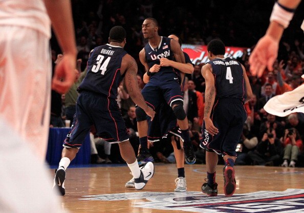 NEW YORK, NY - MARCH 10: Alex Oriakhi #34, Kemba Walker #15 and Jamal Coombs-McDaniel #4 of the Connecticut Huskies celebrate after walker hit the game winning basket against the Pittsburgh Panthers during the quarterfinals of the 2011 Big East Men's Bask