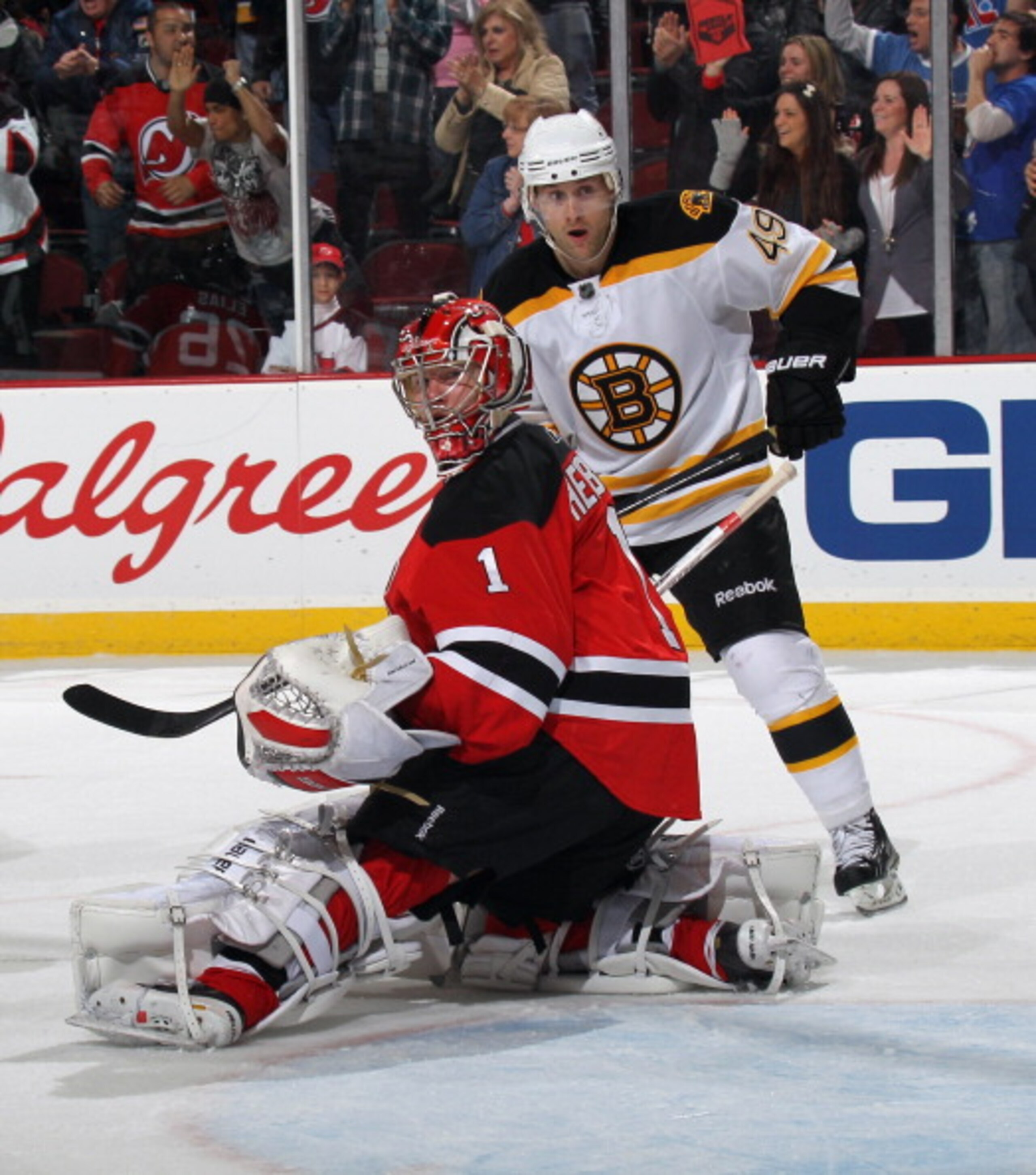 NEWARK, NJ - APRIL 10: Rich Peverley #49 of the Boston Bruins and Johan Hedberg #1 of the New Jersey Devils watch a shot go wide of the net at the Prudential Center on April 10, 2011 in Newark, New Jersey. The Devils defeated the Bruins 3-2. (Photo by Bru