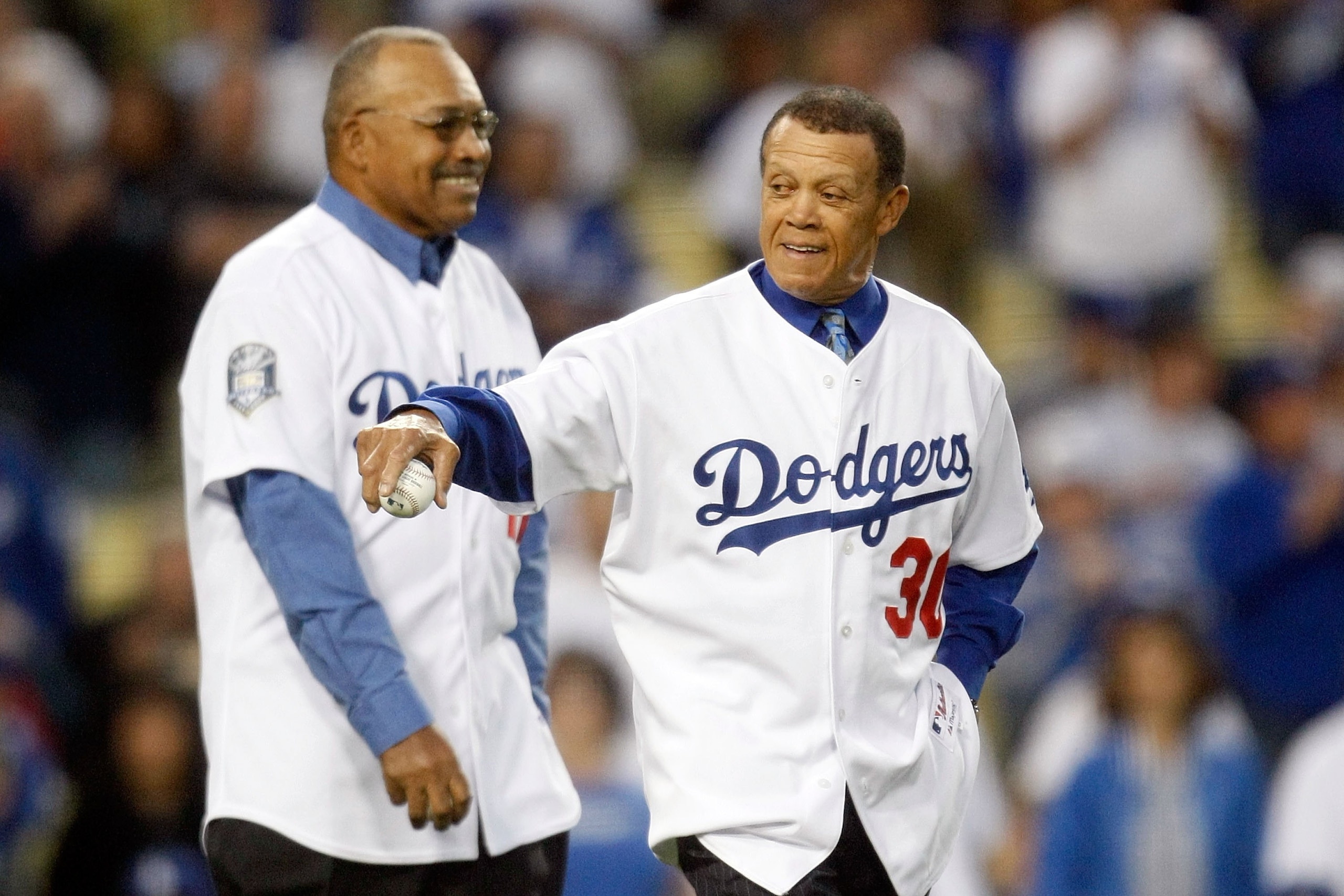 LOS ANGELES, CA - OCTOBER 07:  (R-L) Former Los Angeles Dodgers Maury Wills and Tommy Davis throw out the first pitch before the Dodgers take on the St. Louis Cardinals in Game One of the NLDS during the 2009 MLB Playoffs at Dodger Stadium on October 7, 2