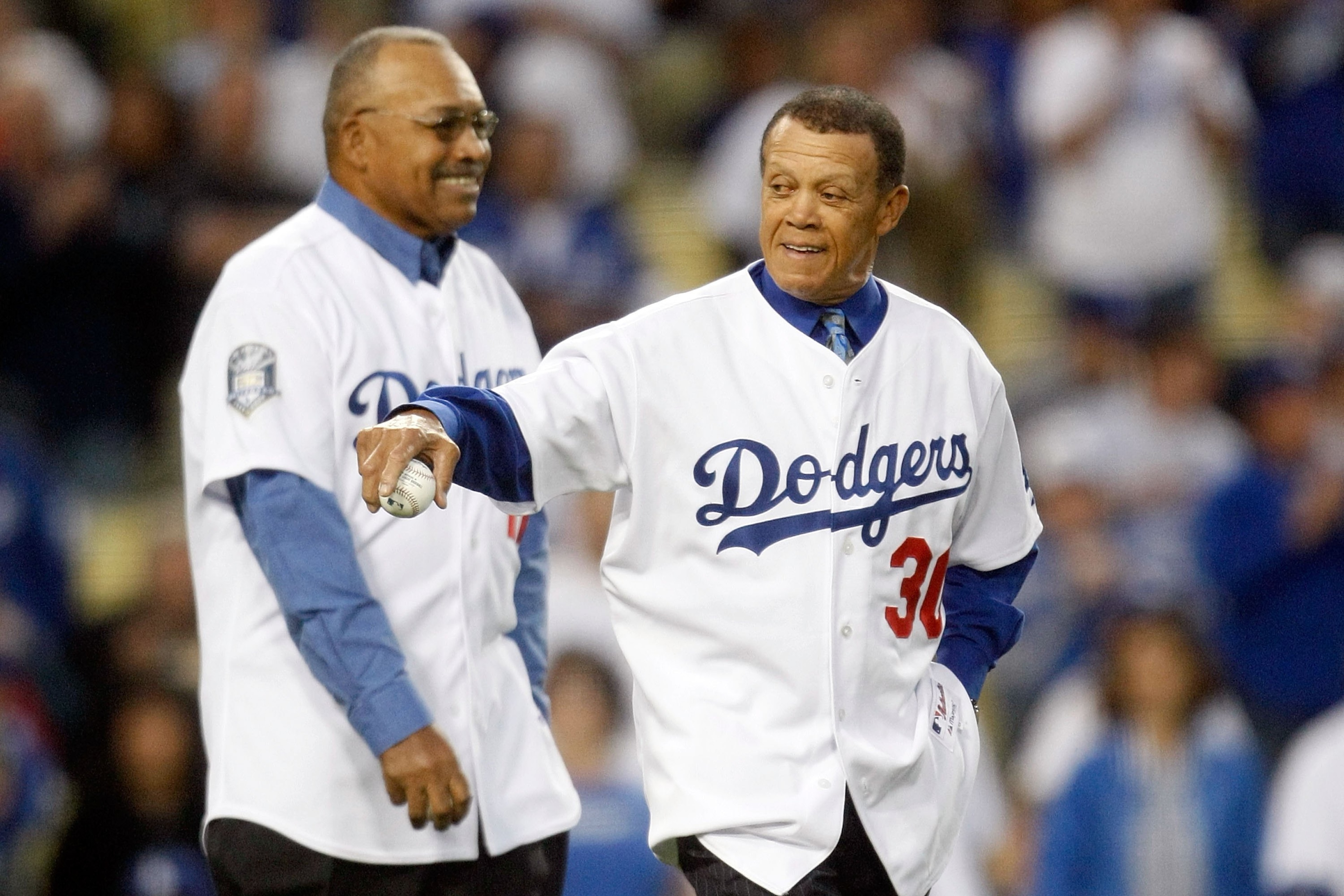 LOS ANGELES, CA - OCTOBER 07:  (R-L) Former Los Angeles Dodgers Maury Wills and Tommy Davis throw out the first pitch before the Dodgers take on the St. Louis Cardinals in Game One of the NLDS during the 2009 MLB Playoffs at Dodger Stadium on October 7, 2