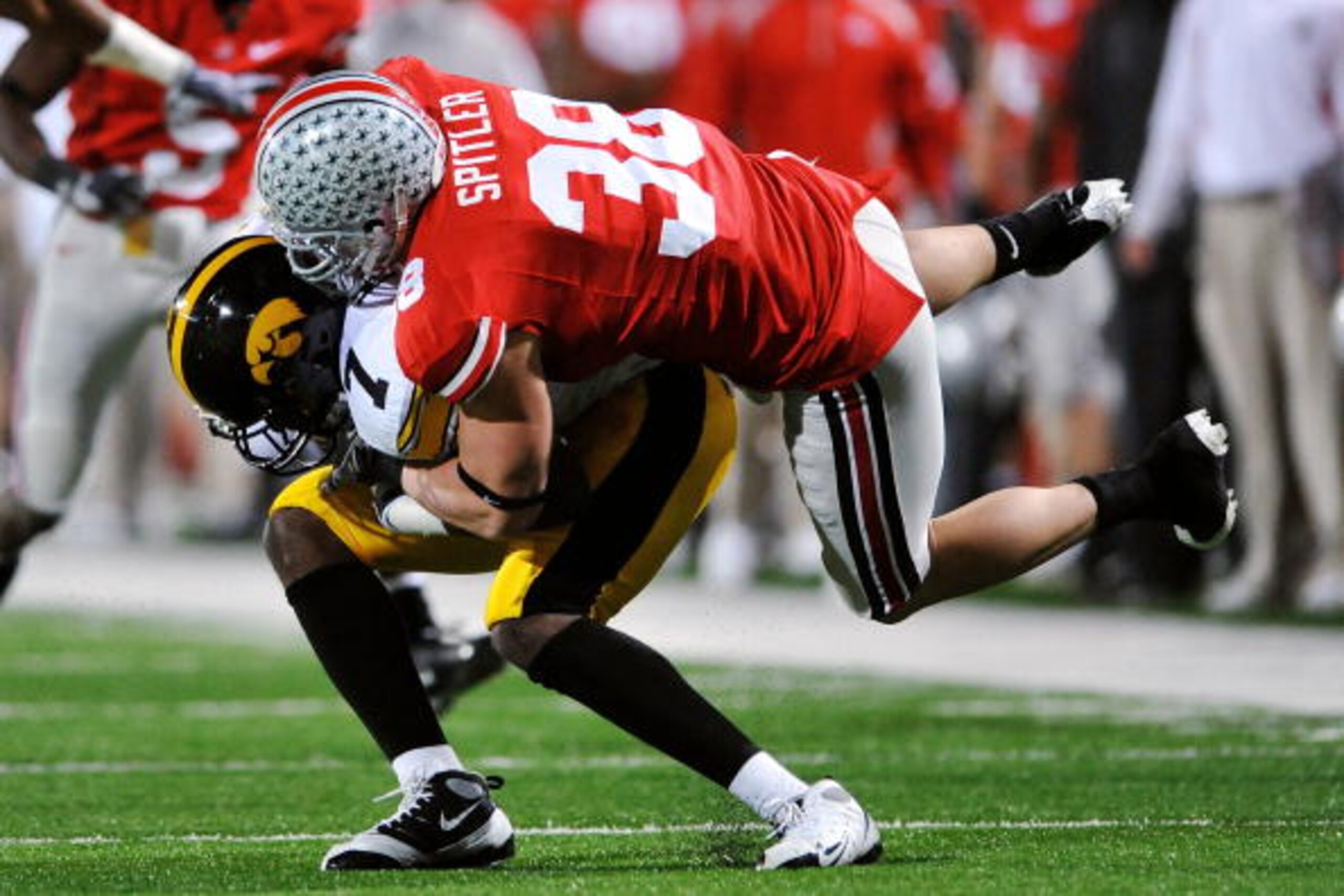 COLUMBUS, OH - NOVEMBER 14: Linebacker Austin Spitler #38 of the Ohio State Buckeyes tackles wide receiver Marvin McNutt #7 of the Iowa Hawkeyes at Ohio Stadium on November 14, 2009 in Columbus, Ohio. (Photo by Jamie Sabau/Getty Images) COLUMBUS, OH - NOVEMBER 14: Linebacker Austin Spitler #38 of the Ohio State Buckeyes tackles wide receiver Marvin McNutt #7 of the Iowa Hawkeyes at Ohio Stadium on November 14, 2009 in Columbus, Ohio. (Photo by Jamie Sabau/Getty Images)