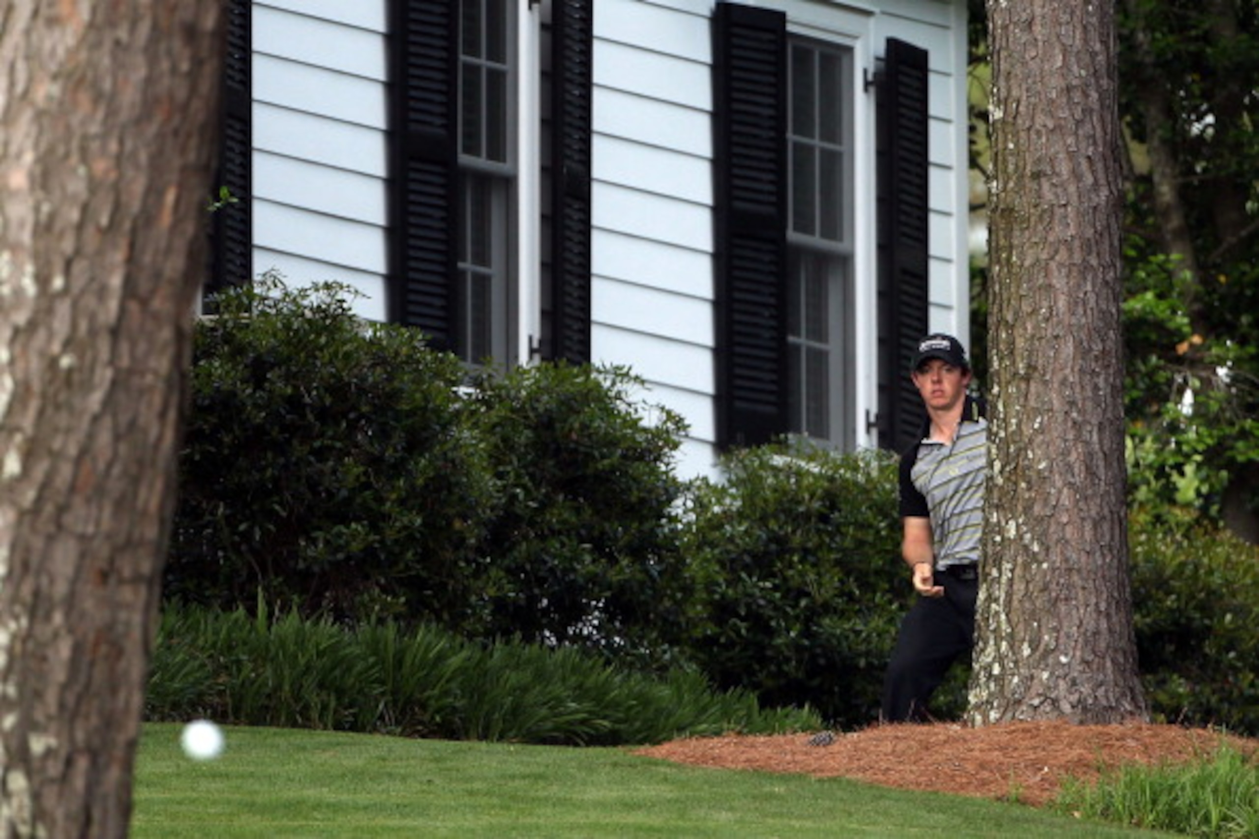 AUGUSTA, GA - APRIL 10:  Rory McIlroy of Northern Ireland plays a shot back to the fairway on the tenth hole after an errant tee shot during the final round of the 2011 Masters Tournament at Augusta National Golf Club on April 10, 2011 in Augusta, Georgia