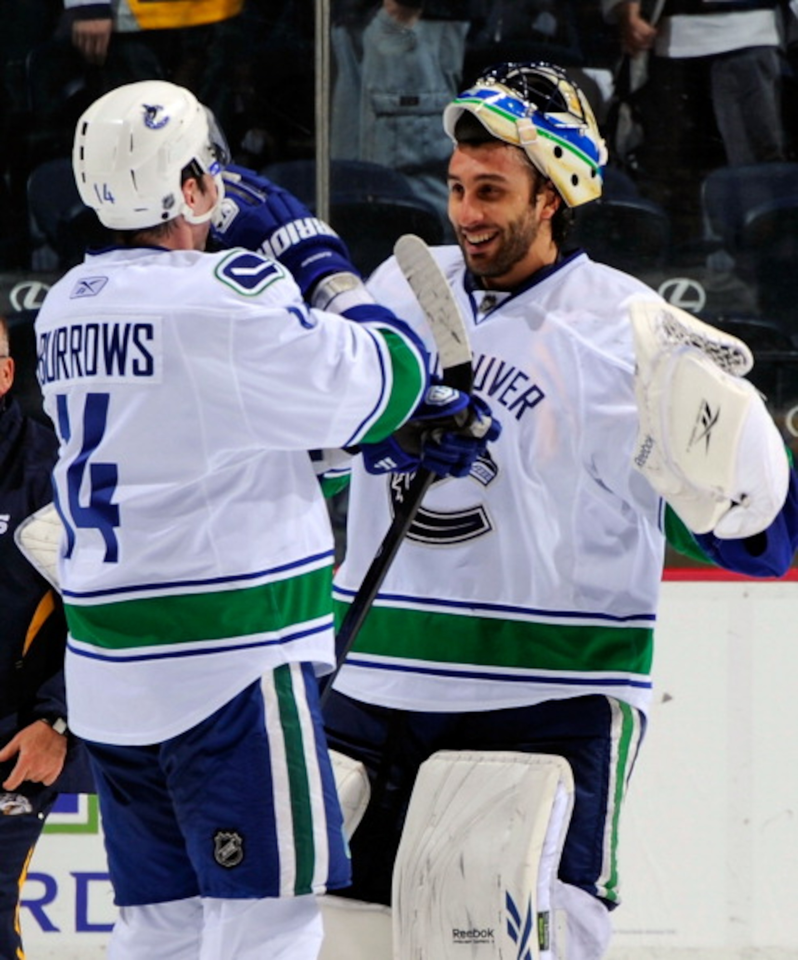NASHVILLE, TN - MARCH 29:  Alexandre Burrows #14 of the Vancouver Canucks congratulates teammate goalie Roberto Luongo #1 on defeating the Nashville Predators on March 29, 2011 at the Bridgestone Arena in Nashville, Tennessee.  (Photo by Frederick Breedon