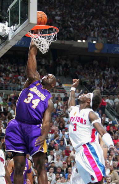 AUBURN HILLS, MI - JUNE 13:  Shaquille O'Neal #34 of the Los Angeles Lakers slam dunks past Ben Wallace #3 of the Detroit Pistons in the first quarter of game four of the 2004 NBA Finals on June 13, 2004 at The Palace of Auburn Hills in Auburn Hills, Mich