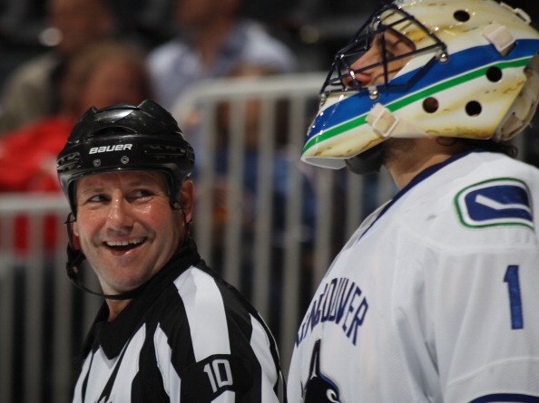 ATLANTA, GA - MARCH 25: Referee Paul Devorski #10 chats with Roberto Luongo #1 of the Vancouver Canucks  at the Philips Arena on March 25, 2011 in Atlanta, Georgia.  (Photo by Bruce Bennett/Getty Images)