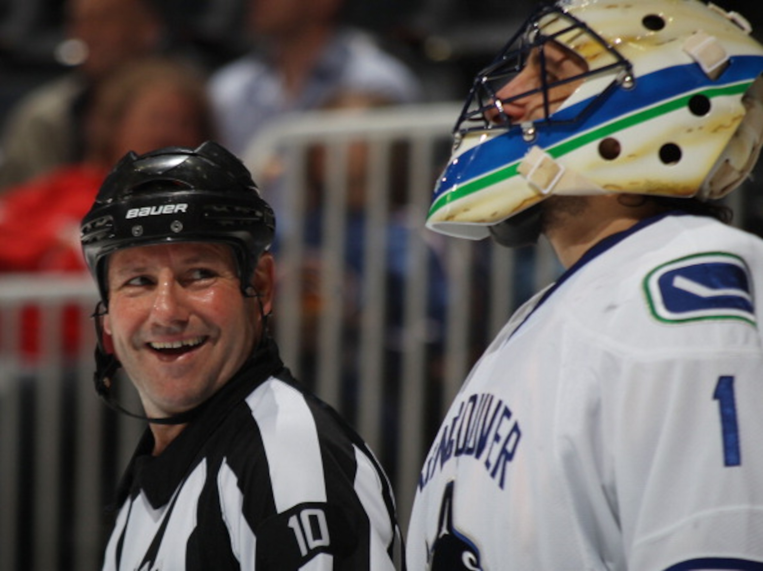 ATLANTA, GA - MARCH 25: Referee Paul Devorski #10 chats with Roberto Luongo #1 of the Vancouver Canucks  at the Philips Arena on March 25, 2011 in Atlanta, Georgia.  (Photo by Bruce Bennett/Getty Images)