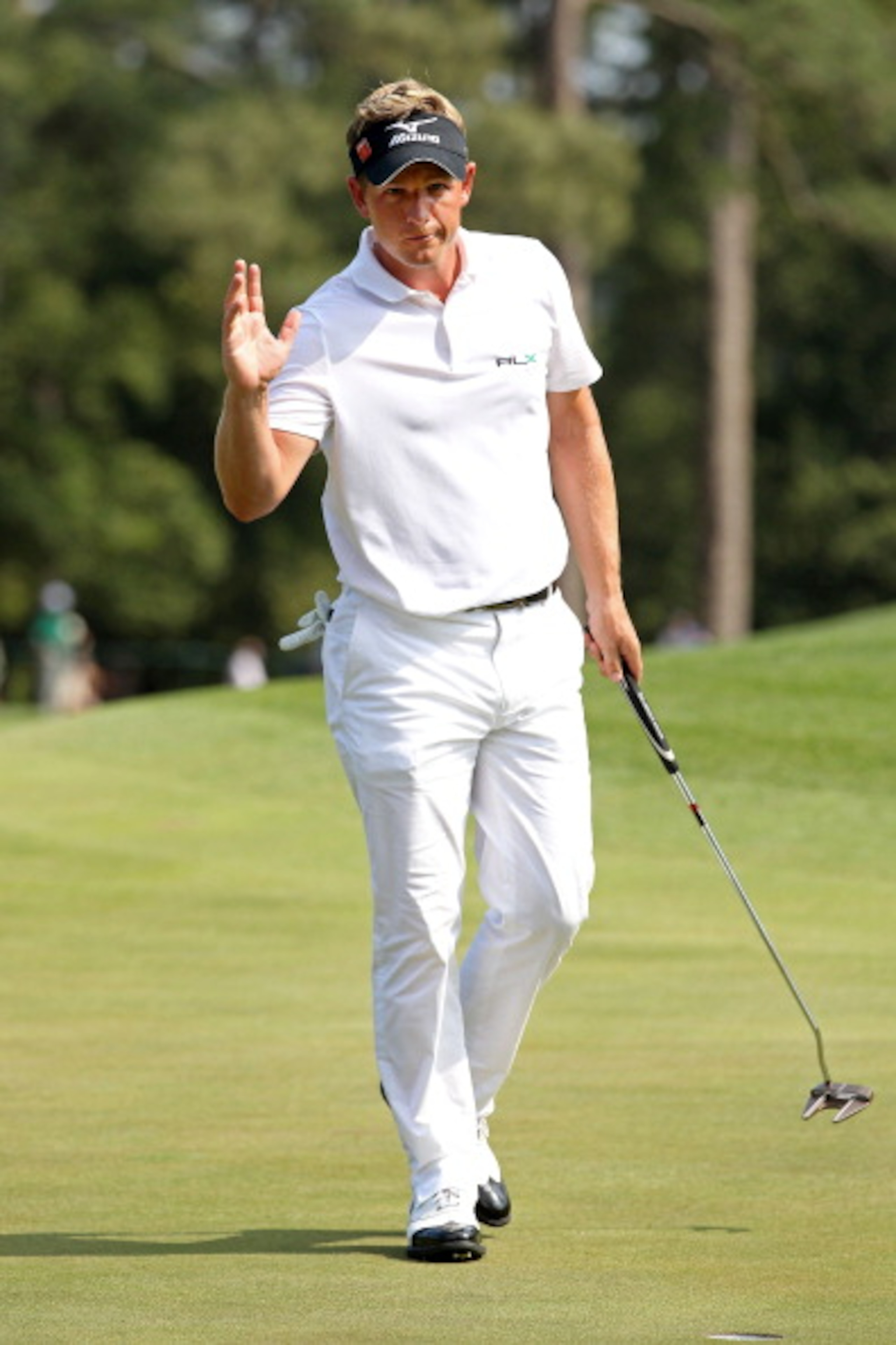 AUGUSTA, GA - APRIL 10:  Luke Donald of England waves to the gallery on the eighth green during the final round of the 2011 Masters Tournament at Augusta National Golf Club on April 10, 2011 in Augusta, Georgia.  (Photo by Andrew Redington/Getty Images)