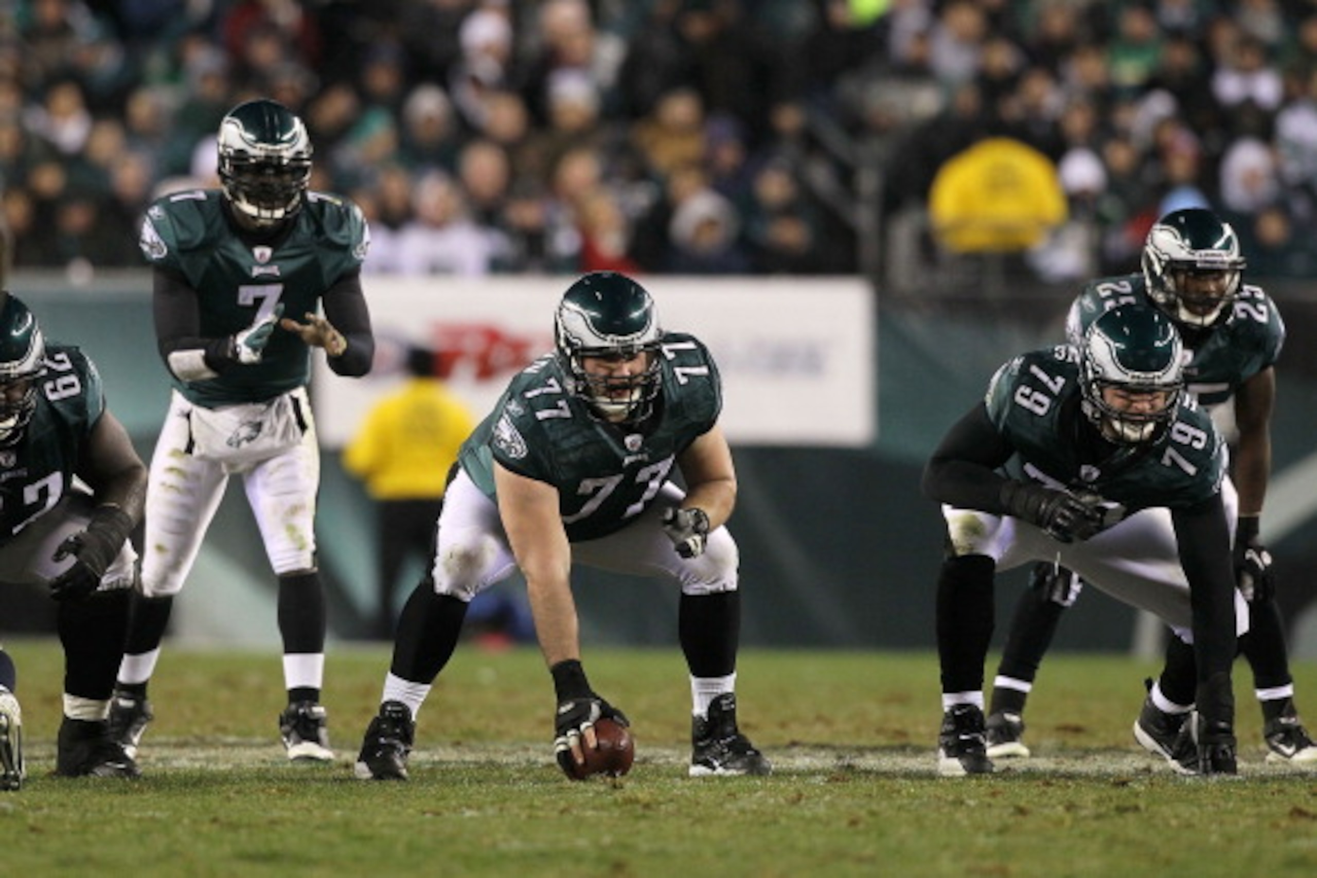 PHILADELPHIA, PA - DECEMBER 02:  Mike McGlynn #77 of the Philadelphia Eagles gets set to snap the ball to quarterback Michael Vick #7 in the shotgun formation against the Houston Texans at Lincoln Financial Field on December 2, 2010 in Philadelphia, Penns