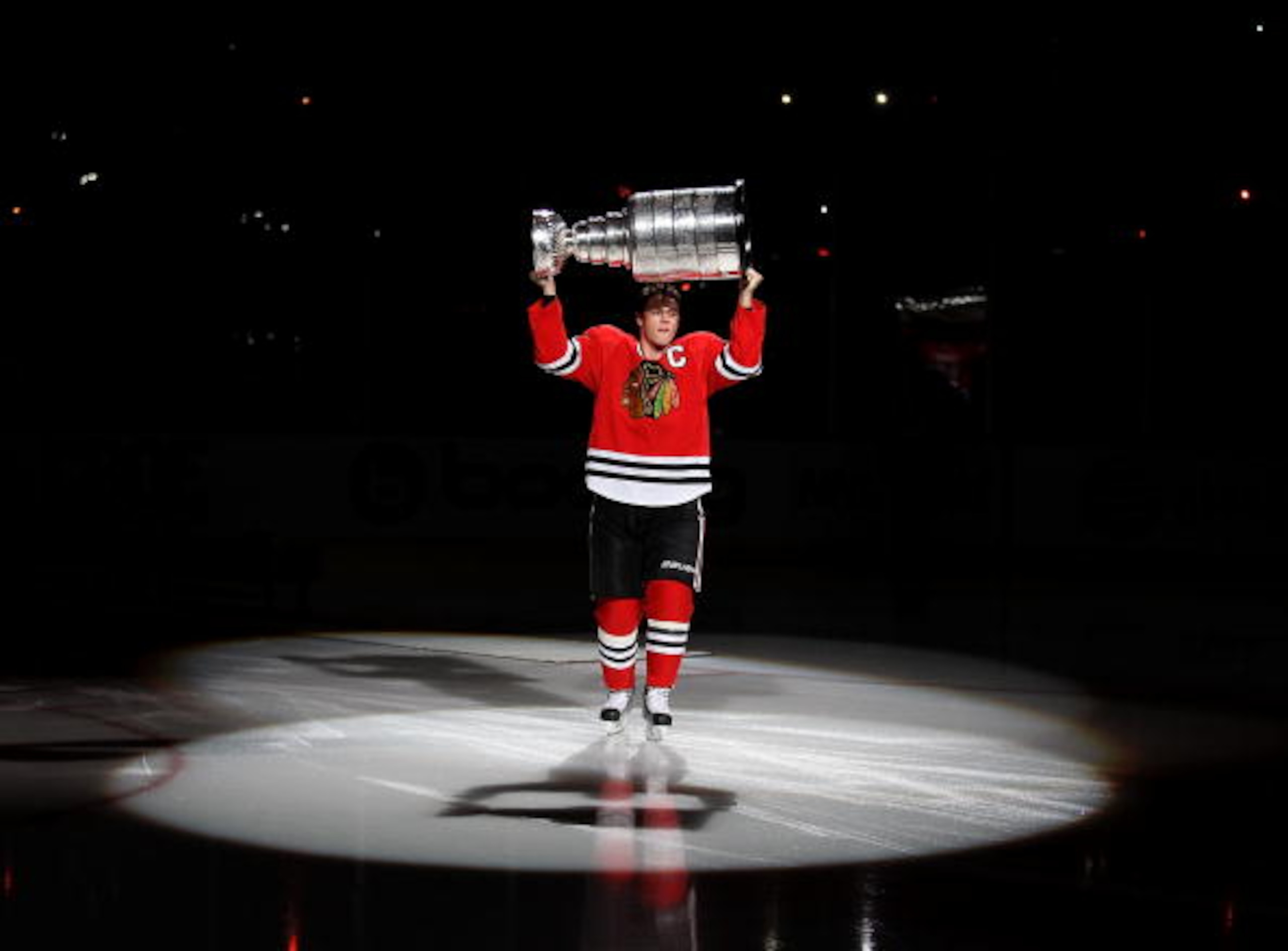 CHICAGO - OCTOBER 09: Jonathan Toews #19 of the Chicago Blackhawks carries the Stanley Cup across the ice in a ceremony before the Blackhawks season home opening game against the Detroit Red Wings at the United Center on October 9, 2010 in Chicago, Illino