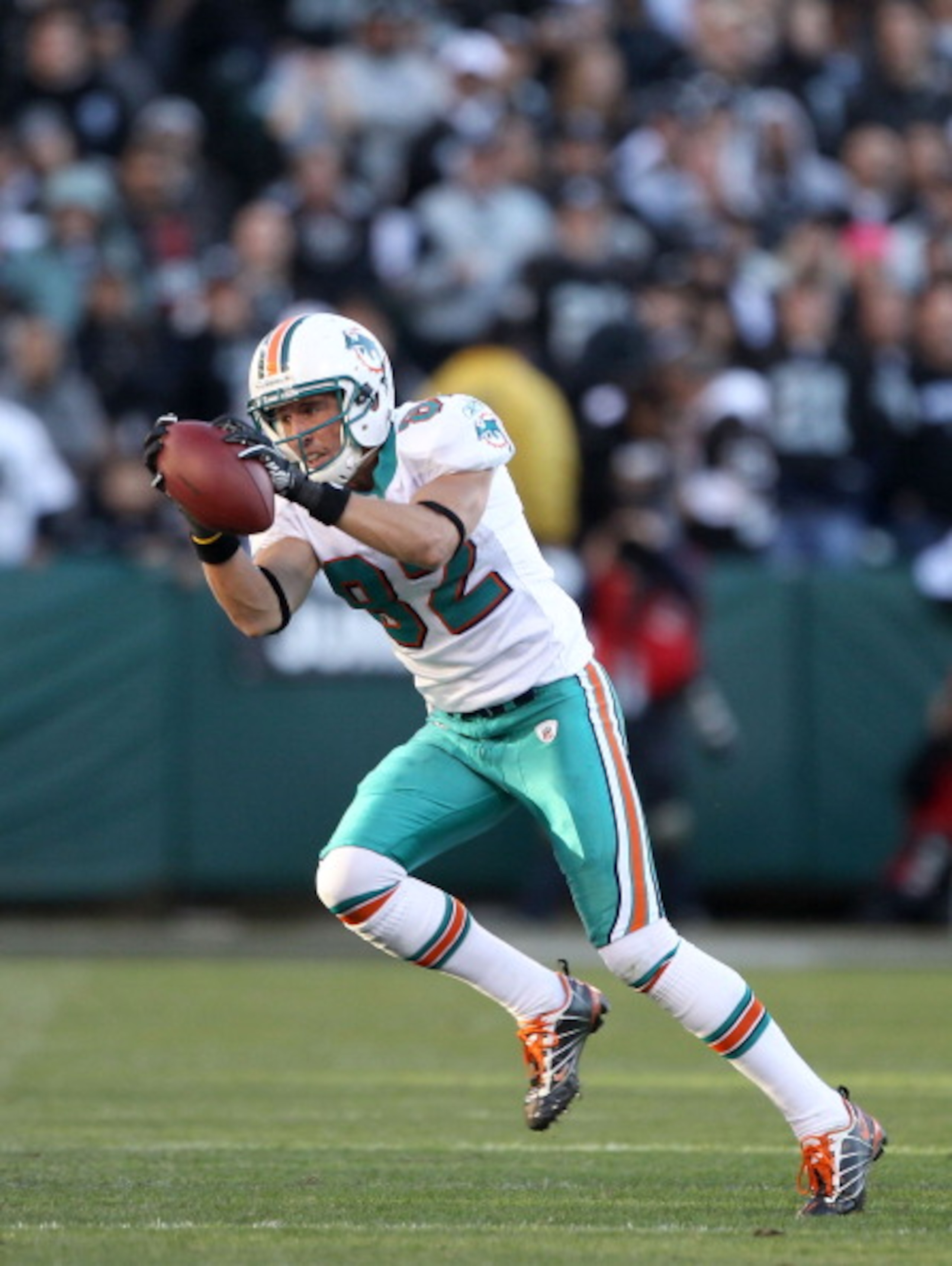 OAKLAND, CA - NOVEMBER 28: Brian Hartline #82 of the Miami Dolphins in action against the Oakland Raiders at Oakland-Alameda County Coliseum on November 28, 2010 in Oakland, California. (Photo by Ezra Shaw/Getty Images) OAKLAND, CA - NOVEMBER 28: Brian Hartline #82 of the Miami Dolphins in action against the Oakland Raiders at Oakland-Alameda County Coliseum on November 28, 2010 in Oakland, California. (Photo by Ezra Shaw/Getty Images)