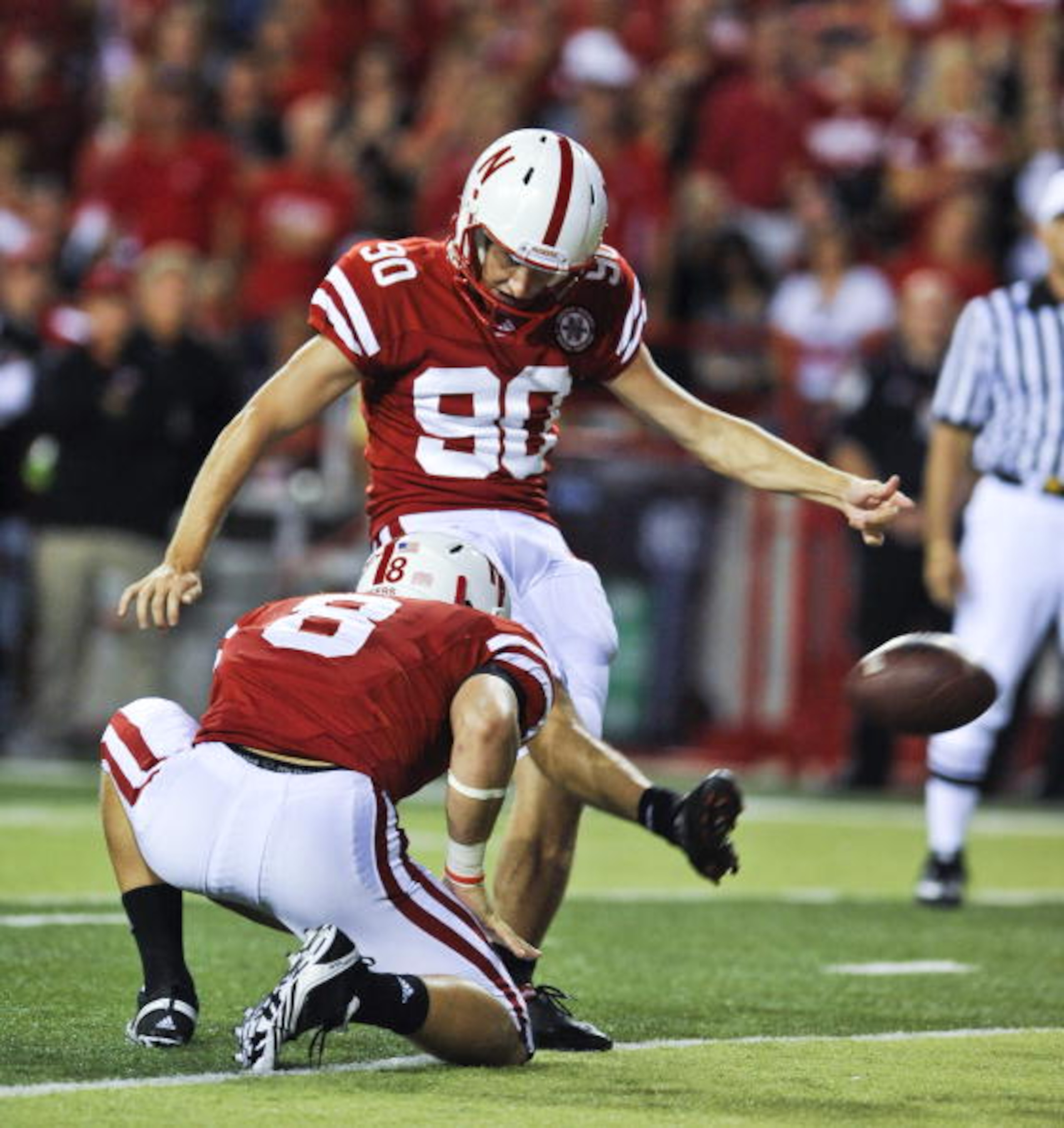 LINCOLN, NE - SEPTEMBER 04: Alex Henry #90 of the Nebraska Cornhuskers  kicks an extra point against the Western Kentucky Hilltoppers  during second half action of their game at Memorial Stadium on September 4, 2010 in Lincoln, Nebraska. Nebraska defeated
