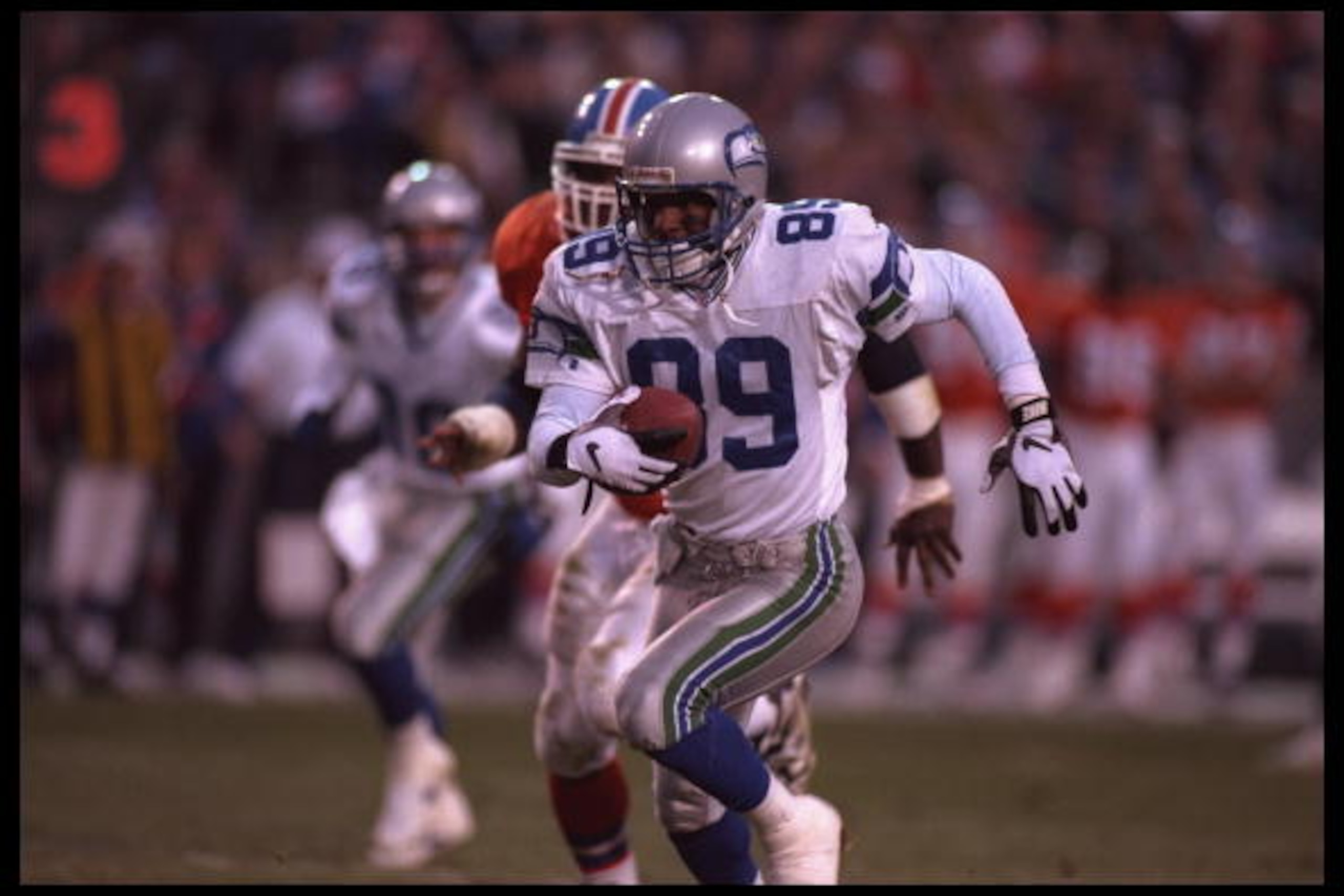 10 Dec 1995:  Wide receiver Brian Blades #89 of the Seattle Seahawks sprints in front of a Denver Bronco pursuer at Mile High Stadium in Denver, Colorado. The Seahawks defeated the Broncos 31-27. Mandatory Credit:  Al Bello/Allsport