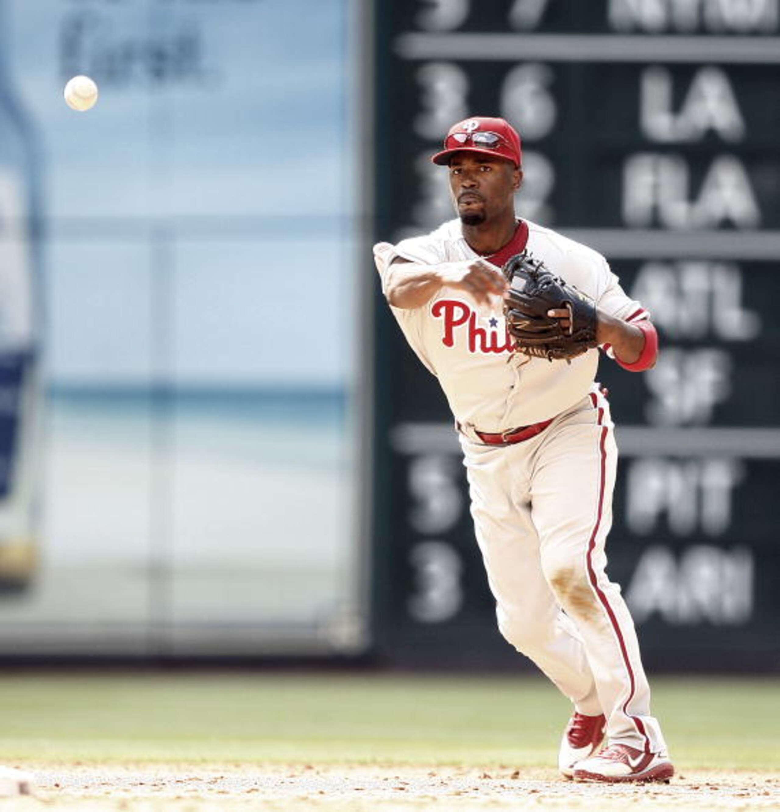 HOUSTON - APRIL 11:  Shortstop Jimmy Rollins #11 of the Philadelphia Phillies throws to first base at Minute Maid Park on April 11, 2010 in Houston, Texas.  (Photo by Bob Levey/Getty Images)