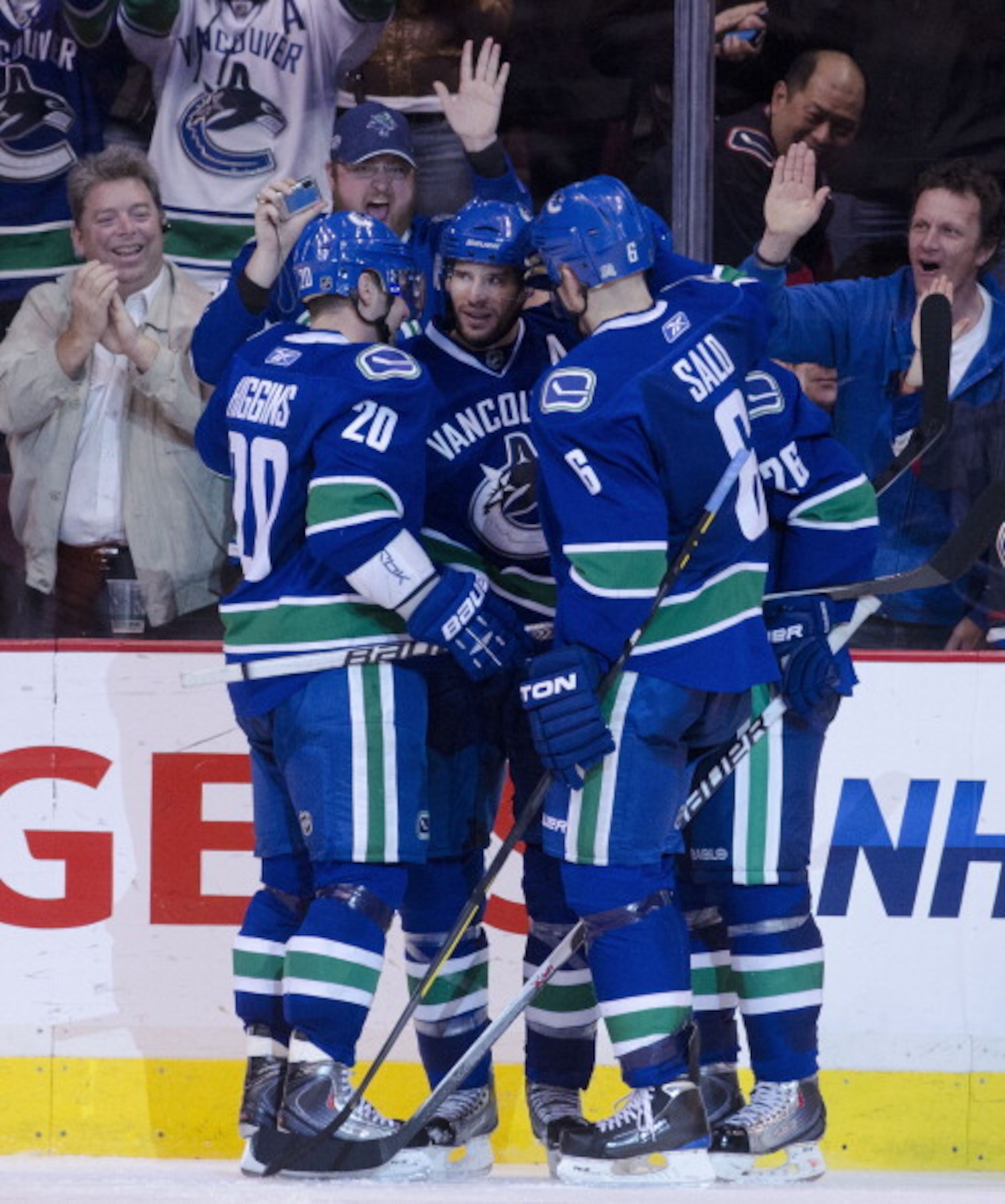 VANCOUVER, CANADA - APRIL 7: Ryan Kesler #17 of the Vancouver Canucks is congratulated by teammates Chris Higgins #20, Sami Salo #6 and Mikael Samuelsson #26 after scoring his third goal of the game against the Minnesota Wild during the third period in NH