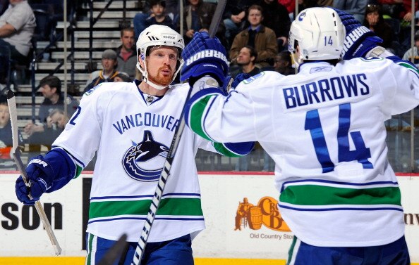 NASHVILLE, TN - MARCH 29:  Daniel Sedin #22 of the Vancouver Canucks congratulates teammate Alexandre Burrows #14 on scoring a goal gainst the Nashville Predators on March 29, 2011 at the Bridgestone Arena in Nashville, Tennessee.  (Photo by Frederick Bre