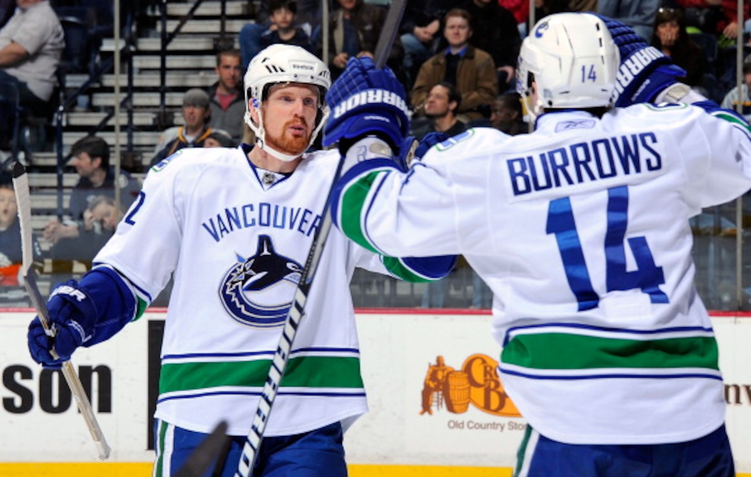 NASHVILLE, TN - MARCH 29:  Daniel Sedin #22 of the Vancouver Canucks congratulates teammate Alexandre Burrows #14 on scoring a goal gainst the Nashville Predators on March 29, 2011 at the Bridgestone Arena in Nashville, Tennessee.  (Photo by Frederick Bre