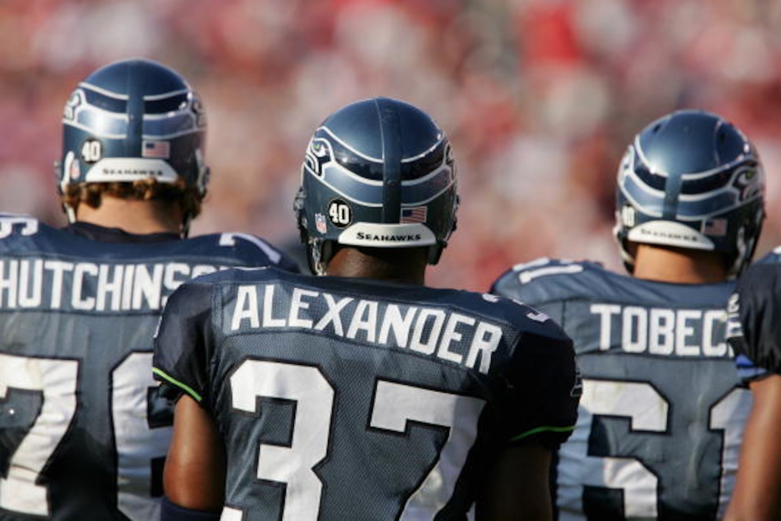 TAMPA, FL - SEPTEMBER 19:  Shaun Alexander #37 of the Seattle Seahawks stands on the field with Steve Hutchinson #76 and Robbie Tobeck #61 during the game against the Tampa Bay Buccaneers at Raymond James Stadium on September 19, 2004 in Tampa, Florida. T