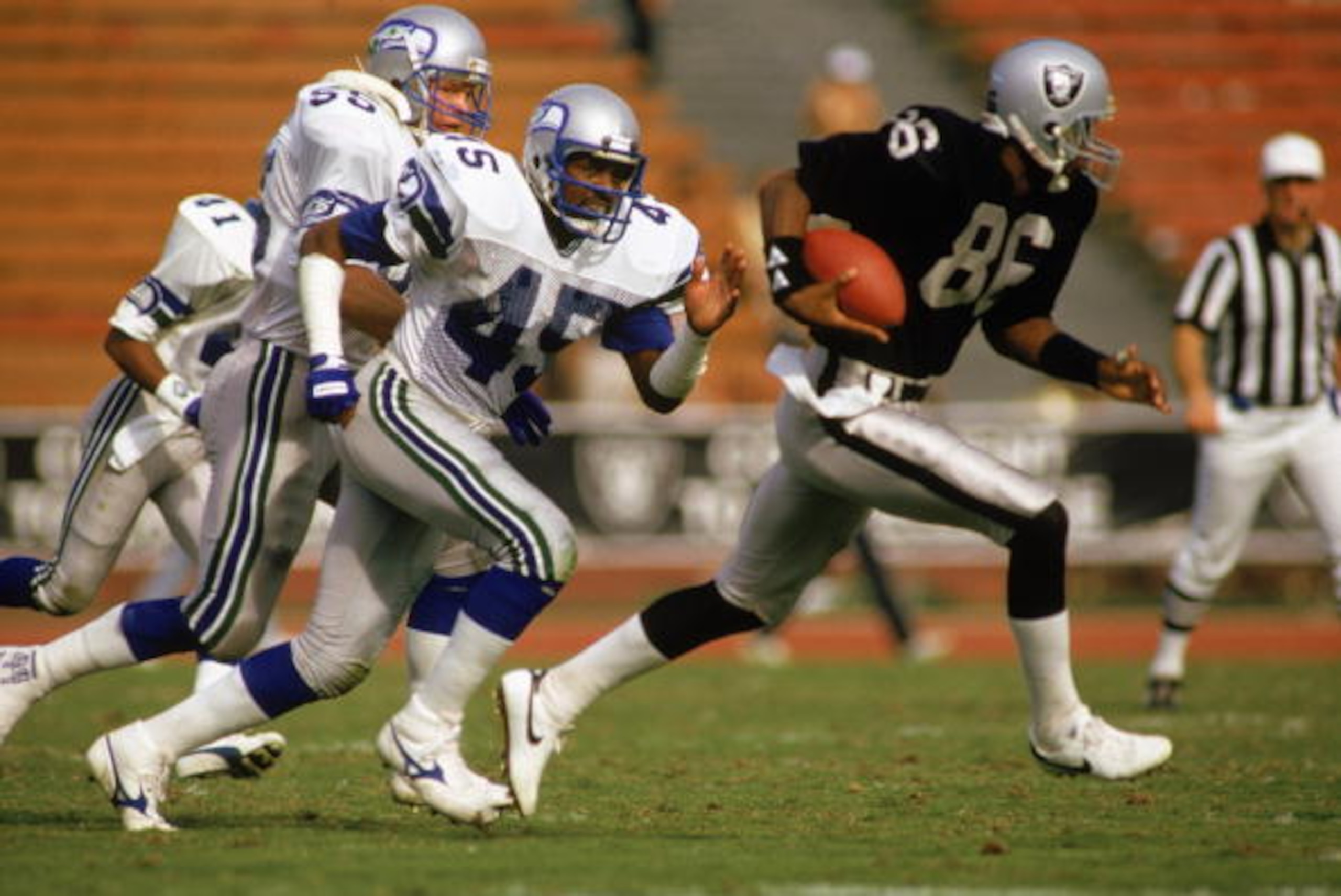 LOS ANGELES - OCTOBER 10:  Safety Kenny Easley #45 of the Seattle Seahawks chases wide receiver Mervyn Fernandez #86 of the Los Angeles Raiders during the NFL game at the Los Angeles Coliseum on October 10, 1987 in Los Angeles, California.  The Seahawks d