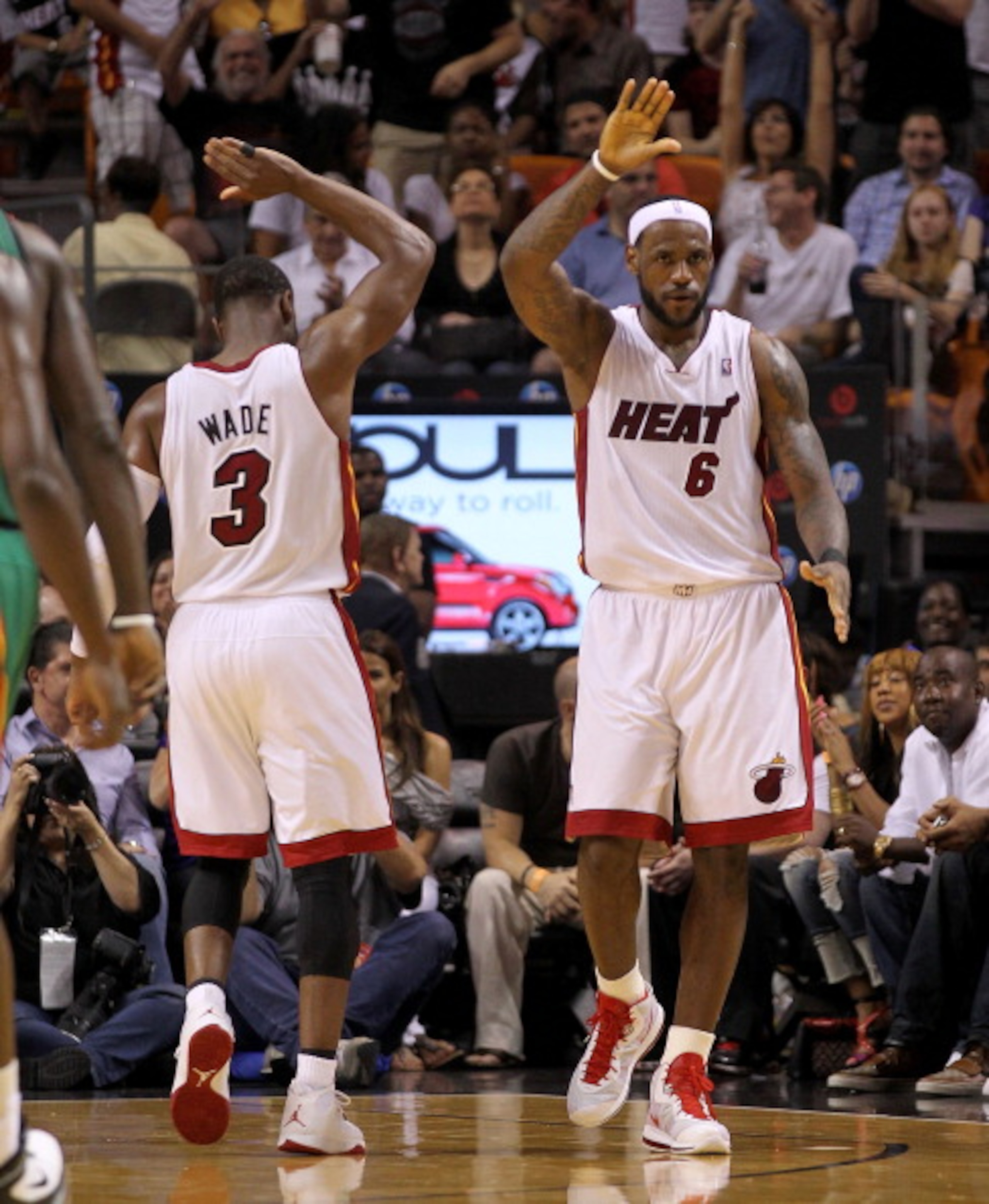MIAMI, FL - APRIL 10:  LeBron James #6 and Dwyane Wade #3 of the Miami Heat high five during a game against the Boston Celtics at American Airlines Arena on April 10, 2011 in Miami, Florida. NOTE TO USER: User expressly acknowledges and agrees that, by do
