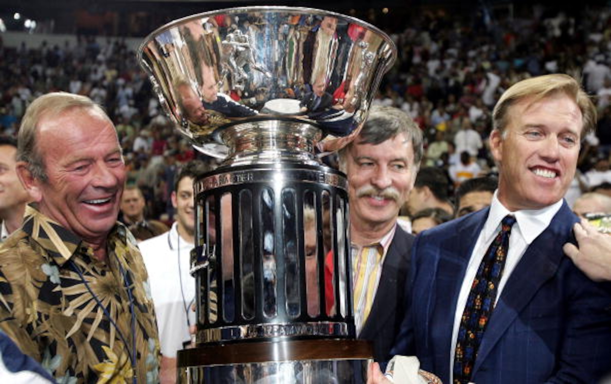 LAS VEGAS - JUNE 12:  (L-R) Owners Pat Bowlen, Stan Kroenke and John Elway of the Colorado Crush pose with the trophy after a 51-48 win over the Georgia Force in Arena Bowl XIX on June 12, 2005 at the Thomas and Mack Center in Las Vegas, Nevada.  (Photo b