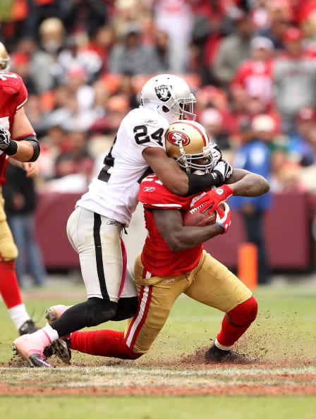 SAN FRANCISCO - OCTOBER 17:  Frank Gore #21 of the San Francisco 49ers is tackled by Michael Huff #24 of the Oakland Raiders at Candlestick Park on October 17, 2010 in San Francisco, California.  (Photo by Ezra Shaw/Getty Images)