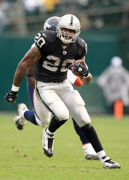 OAKLAND, CA - DECEMBER 19:  Darren McFadden #20 of the Oakland Raiders runs with the ball during their game against the Denver Broncos at Oakland-Alameda County Coliseum on December 19, 2010 in Oakland, California.  (Photo by Ezra Shaw/Getty Images)