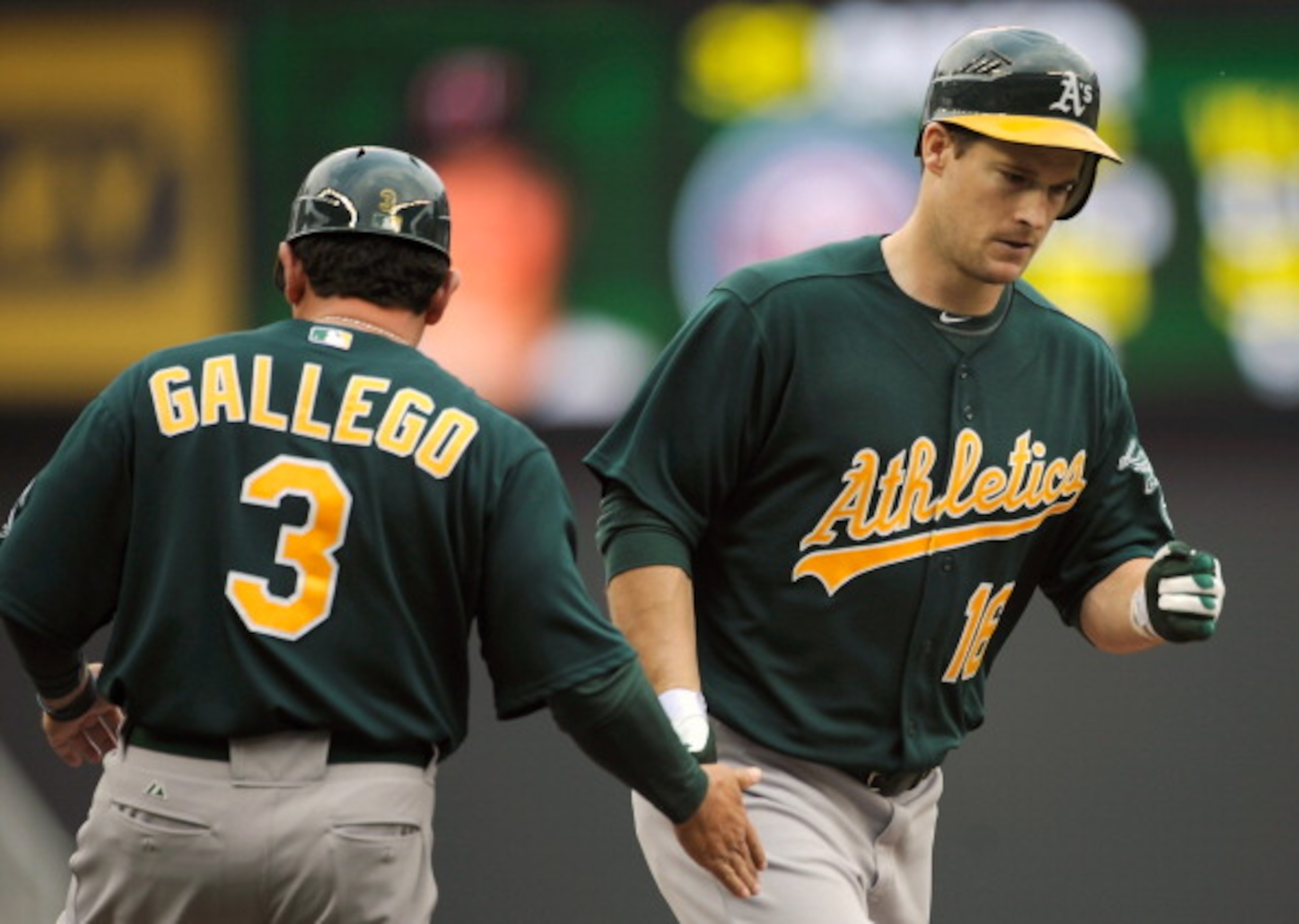MINNEAPOLIS, MN - APRIL 10: Third base coach Mike Gallegro #3 of the Oakland Athletics congratulates Josh Willingham #16 as he rounds the bases following a solo home run off of Scott Baker #30 of the Minnesota Twins during the fourth inning of their game MINNEAPOLIS, MN - APRIL 10: Third base coach Mike Gallegro #3 of the Oakland Athletics congratulates Josh Willingham #16 as he rounds the bases following a solo home run off of Scott Baker #30 of the Minnesota Twins during the fourth inning of their game