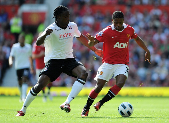 MANCHESTER, ENGLAND - APRIL 09:  Patrice Evra of Manchester United is closed down by Dickson Etuhu of Fulham during the Barclays Premier League match between Manchester United and Fulham at Old Trafford on April 9, 2011 in Manchester, England.  (Photo by