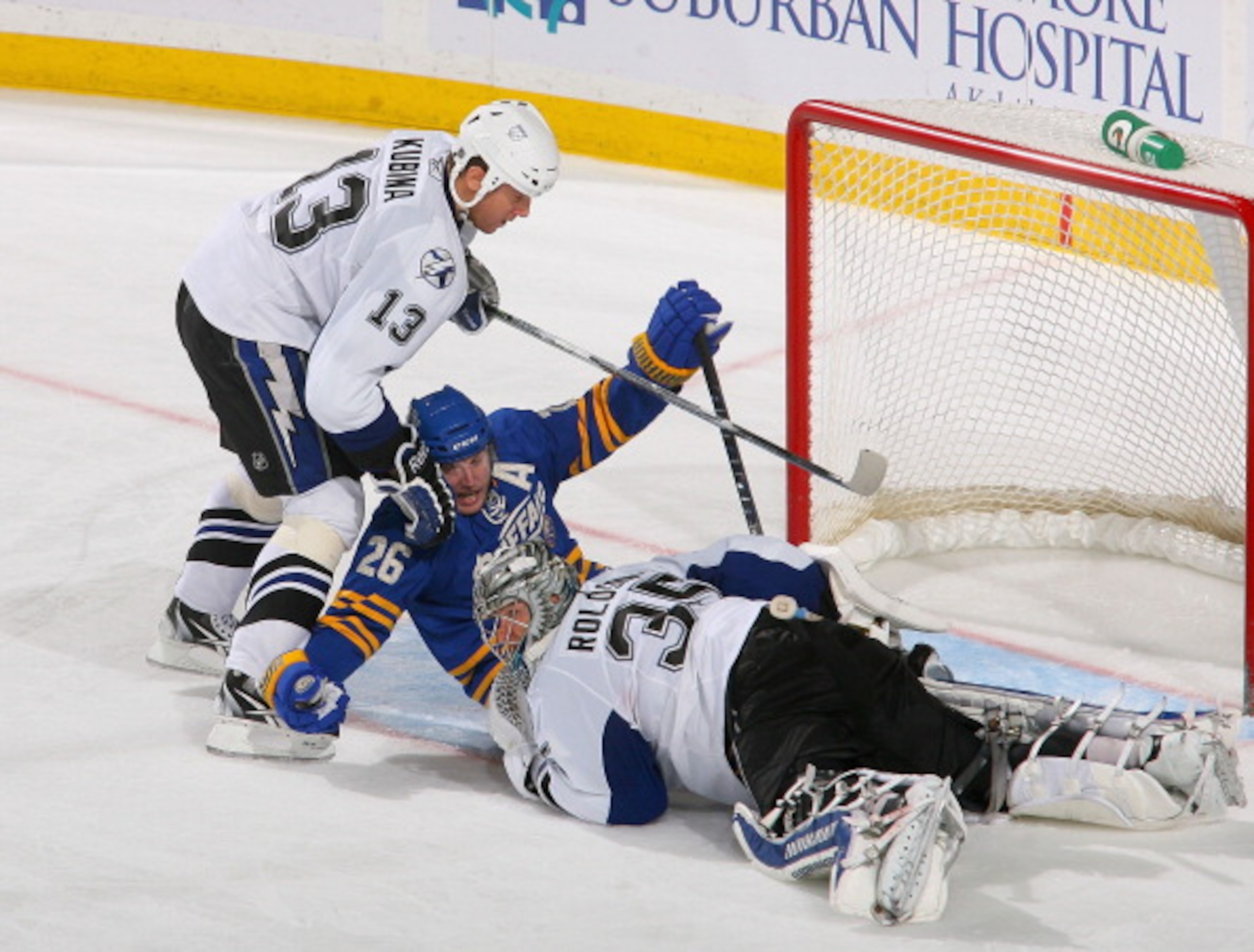 BUFFALO, NY - APRIL 05:  Thomas Vanek #26 of the Buffalo Sabres is held down by Pavel Kubina #13 and Dwayne Roloson #35 of the Tampa Bay Lightning at HSBC Arena on April 5, 2011 in Buffalo, New York.  (Photo by Rick Stewart/Getty Images)
