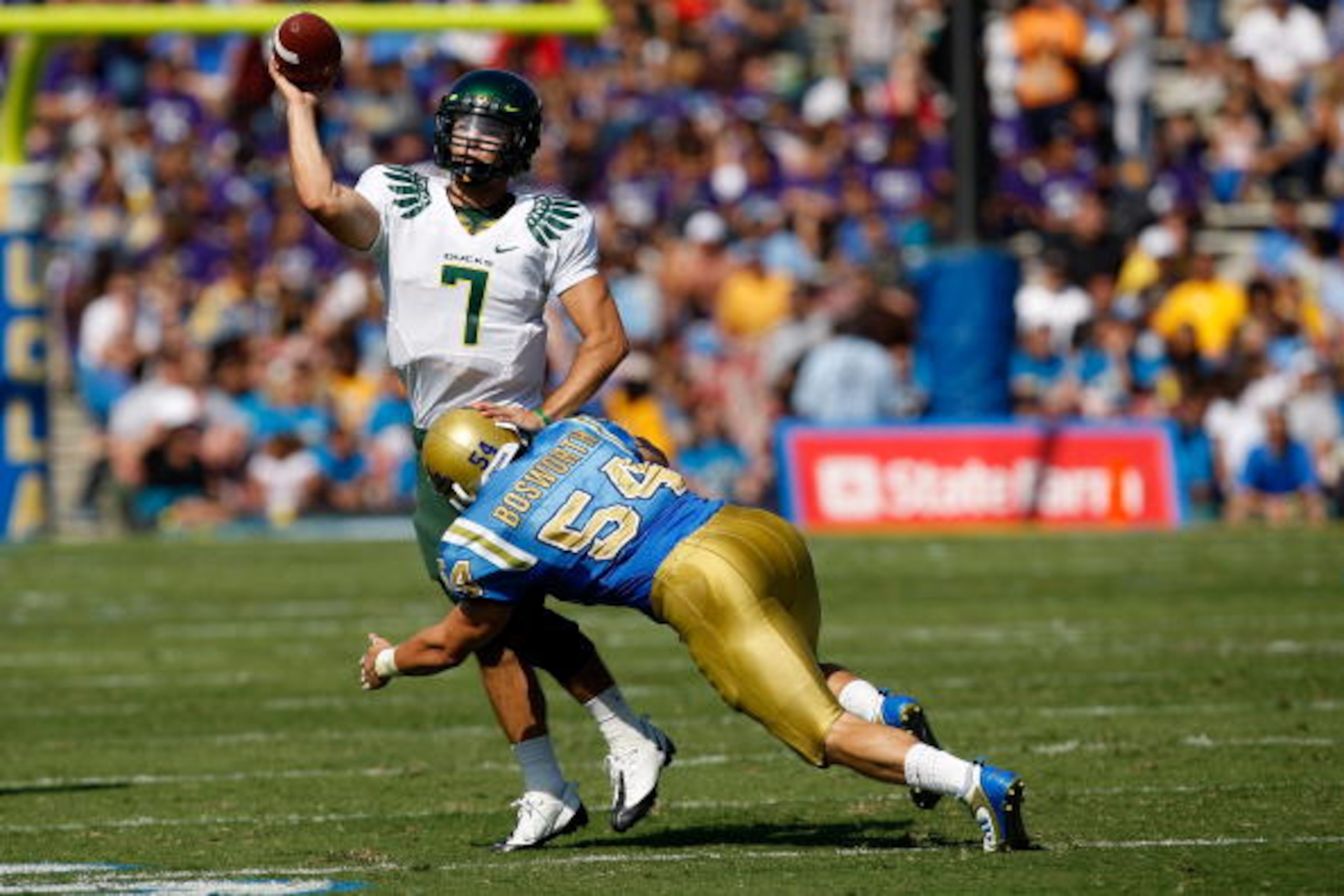 PASADENA, CA. - OCTOBER 10:  Kyle Bosworth #54 of the UCLA Bruins hits Nate Costa #7 the Oregon Ducks on October 10, 2009 at the Rosebowl in Pasadena, California. The Ducks defeated the Bruins 24-10  (Photo by Jacob De golish/Getty Images)