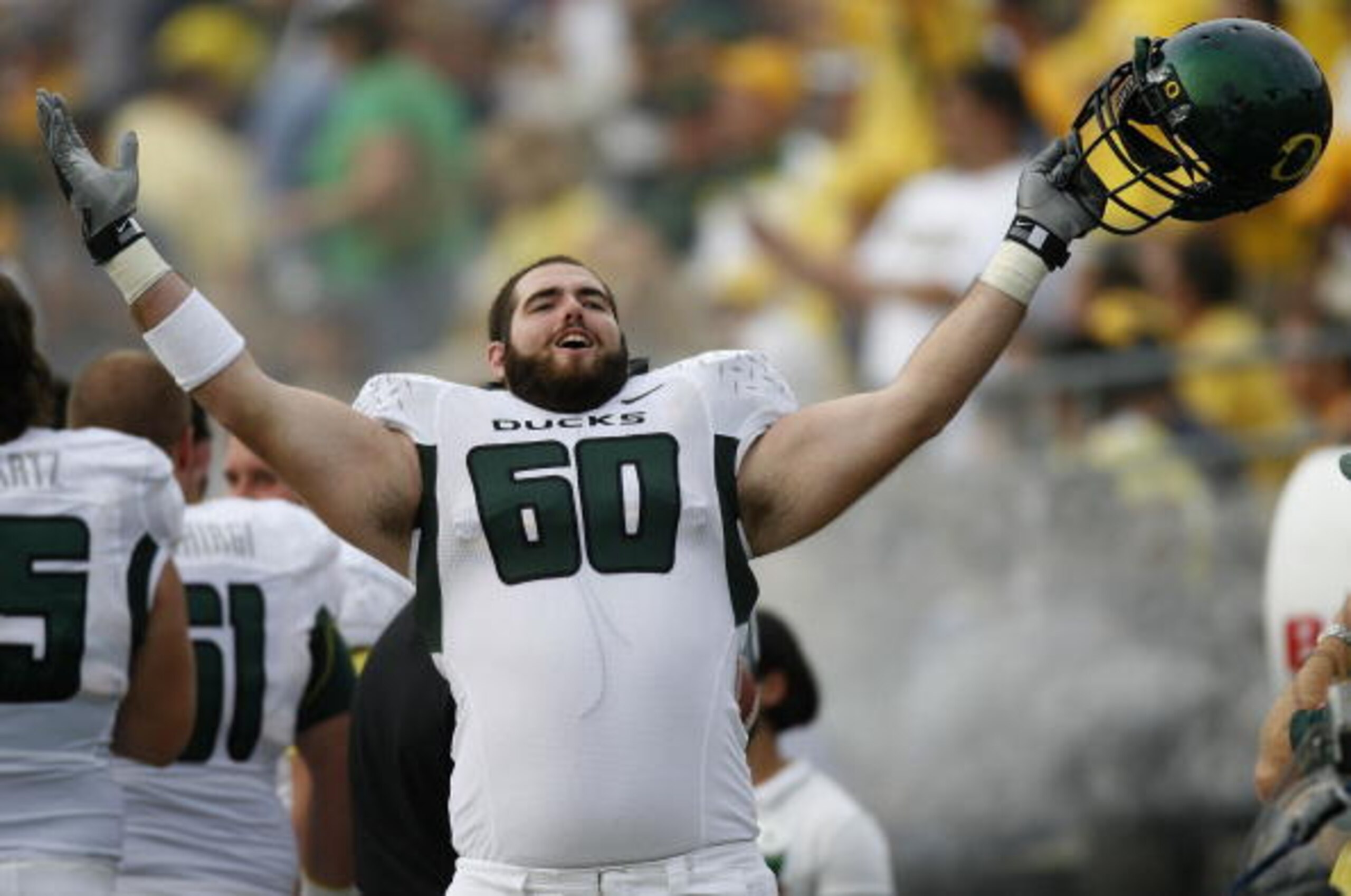 ANN ARBOR, MI - SEPTEMBER 08: Max Unger #60 of the Oregon Ducks celebrates on the sideline late in the fourth quarter against the Michigan Wolverines on September 8, 2007 at Michigan Stadium in Ann Arbor, Michigan. Oregon won the game 39-7.  (Photo By Gre