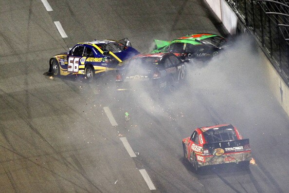 FORT WORTH, TX - APRIL 09:  Martin Truex Jr., driver of the #56 NAPA Toyota, Mark Martin, driver of the #5 GoDaddy.com Chevrolet, and Regan Smith, driver of the #78 farmamerican.org Chevrolet, crash on the backstretch as Jamie McMurray, driver of the #1 B