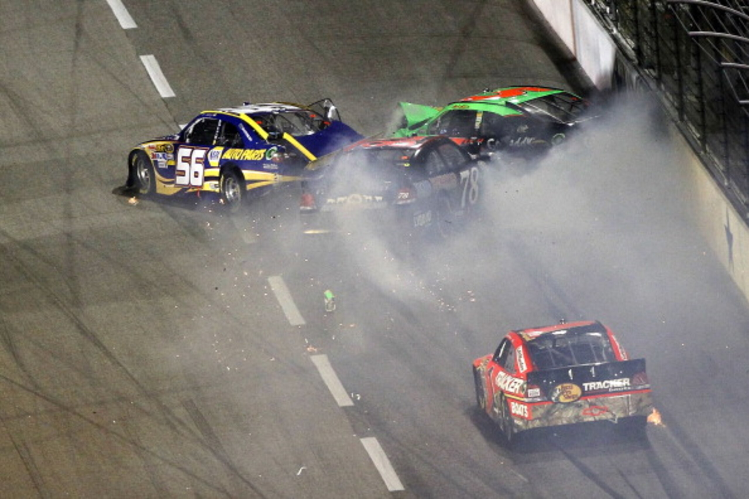FORT WORTH, TX - APRIL 09:  Martin Truex Jr., driver of the #56 NAPA Toyota, Mark Martin, driver of the #5 GoDaddy.com Chevrolet, and Regan Smith, driver of the #78 farmamerican.org Chevrolet, crash on the backstretch as Jamie McMurray, driver of the #1 B