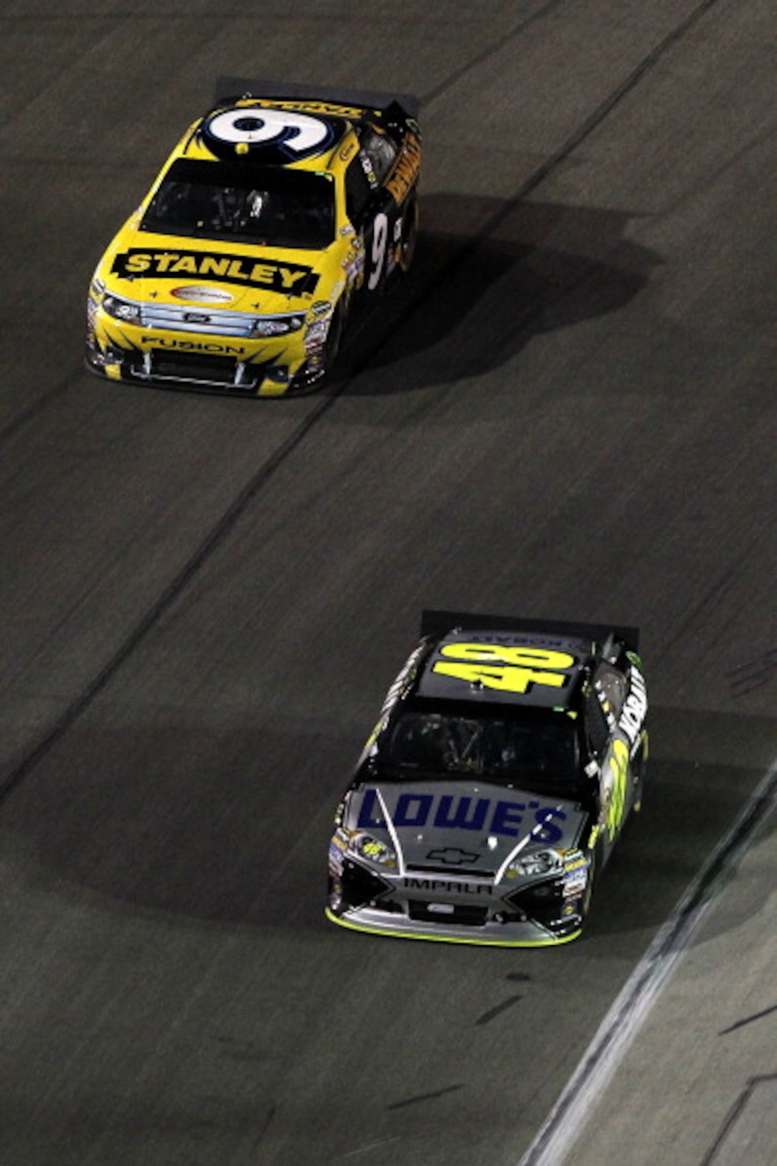 FORT WORTH, TX - APRIL 09:  Jimmie Johnson, driver of the #48 Lowe's Chevrolet, and Marcos Ambrose, driver of the #9 Stanley Ford, drive during the NASCAR Sprint Cup Series Samsung Mobile 500 at Texas Motor Speedway on April 9, 2011 in Fort Worth, Texas. 