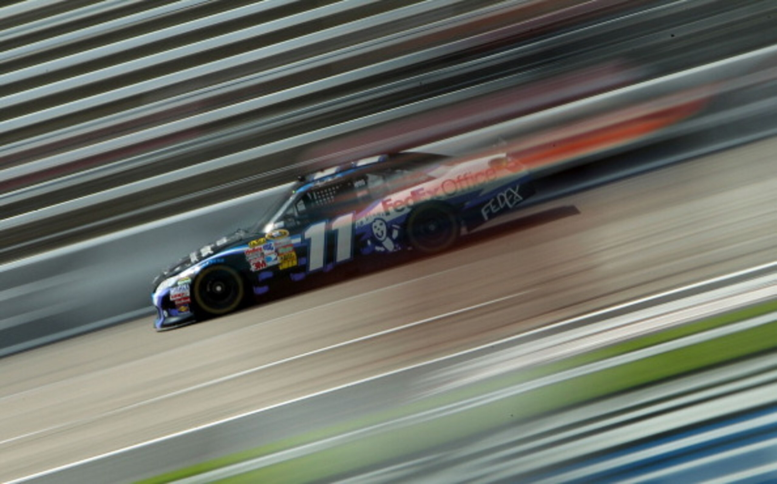 FORT WORTH, TX - APRIL 08:  Denny Hamlin drives the #11 FedEx Office/March of Dimes Toyota during practice for the NASCAR Sprint Cup Series Samsung Mobile 500 at Texas Motor Speedway on April 8, 2011 in Fort Worth, Texas.  (Photo by Jonathan Ferrey/Getty 
