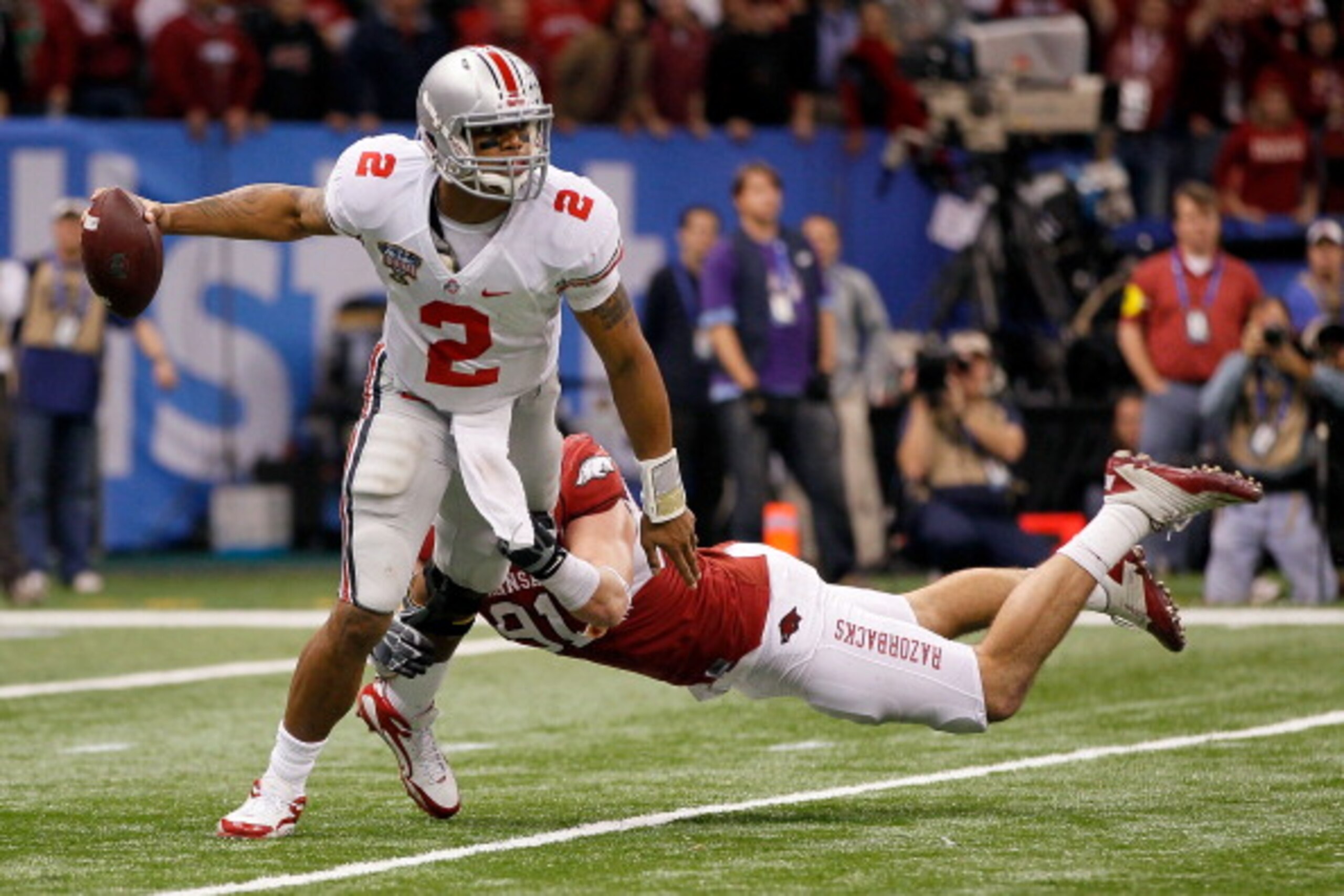 NEW ORLEANS, LA - JANUARY 04:  Terrelle Pryor #2 of the Ohio State Buckeyes looks to avoid the sack attempt by Jake Bequette #91 of the Arkansas Razorbacks in the second half during the Allstate Sugar Bowl at the Louisiana Superdome on January 4, 2011 in