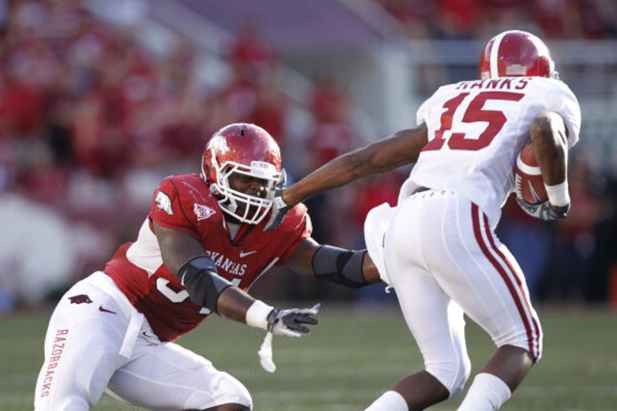 FAYETTEVILLE - SEPTEMBER 25: Darius Hanks #15 of the Alabama Crimson Tide tries to get around a tackle attempt by Jerry Franklin #34 of the Arkansas Razorbacks at Donald W. Reynolds Razorback Stadium on September 25, 2010 in Fayetteville, Arkansas. Alabam