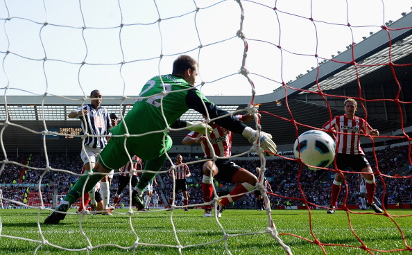 SUNDERLAND, ENGLAND - APRIL 09: Peter Odemwingie of West Bromwich Albion fires home his first half goal  during the Barclays Premier League match between Sunderland and West Bromwich Albion at The Stadium of Light on April 9, 2011 in Sunderland, England.