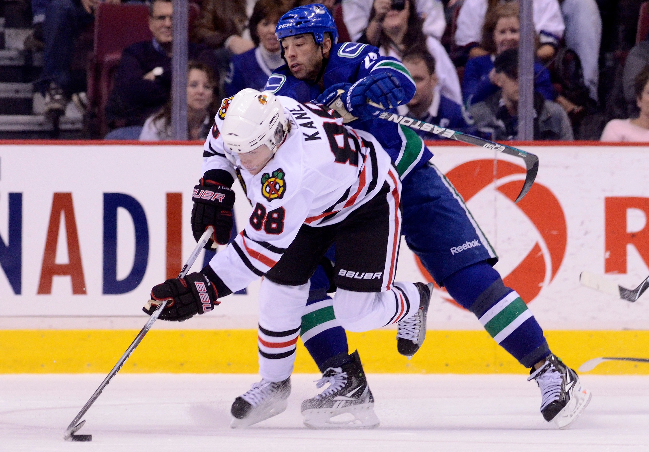VANCOUVER, CANADA - FEBRUARY 4: Manny Malhotra #27 of the Vancouver Canucks tries to knock Patrick Kane #88 of the Chicago Blackhawks off the puck during the second period in NHL action on February 04, 2011 at Rogers Arena in Vancouver, British Columbia,
