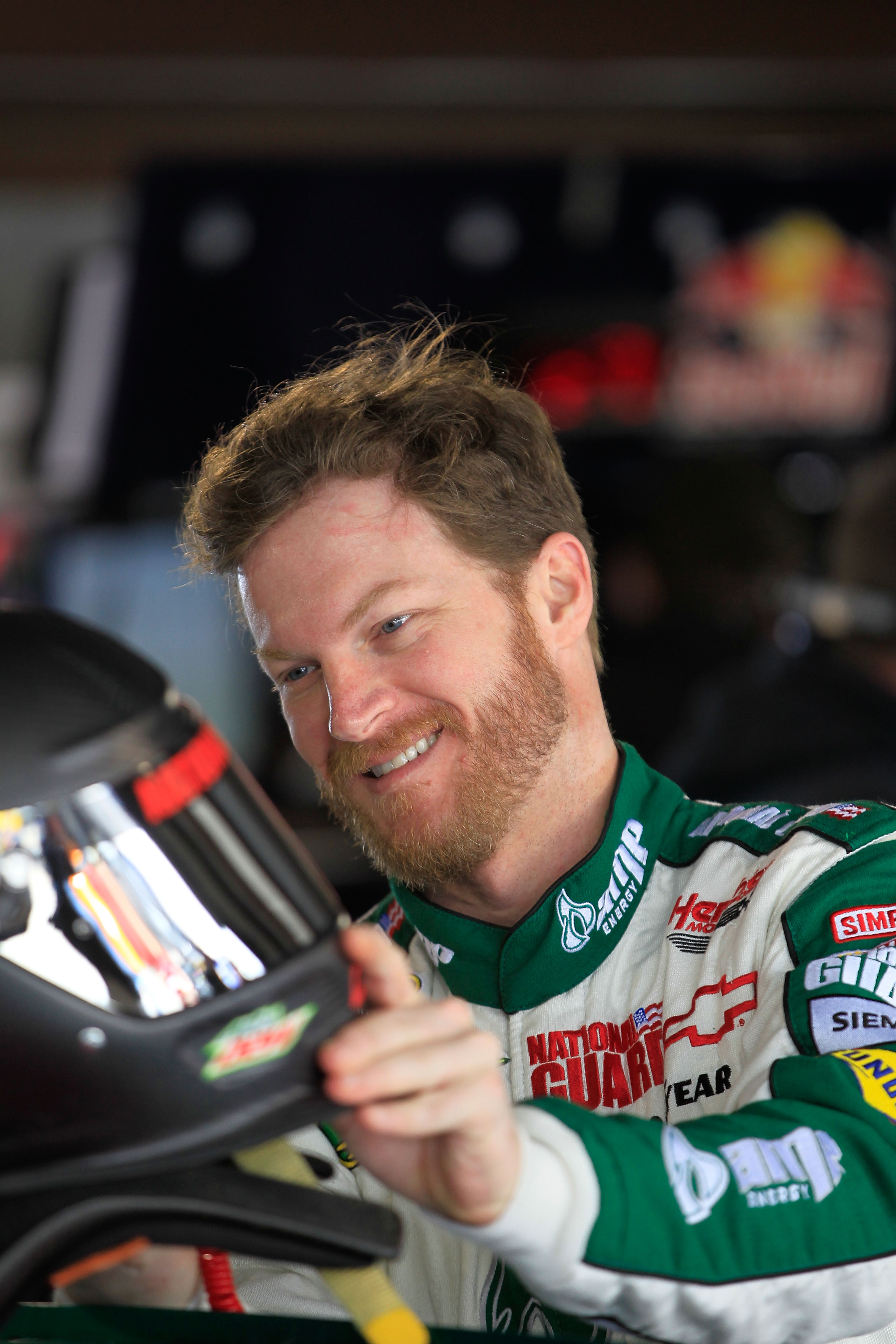 MARTINSVILLE, VA - APRIL 01:  Dale Earnhardt Jr., driver of the #88 Amp Energy/National Guard Chevrolet, puts on his helmet in the garage prior to practice for the NASCAR Sprint Cup Series Goody's Fast Relief 500 at Martinsville Speedway on April 1, 2011