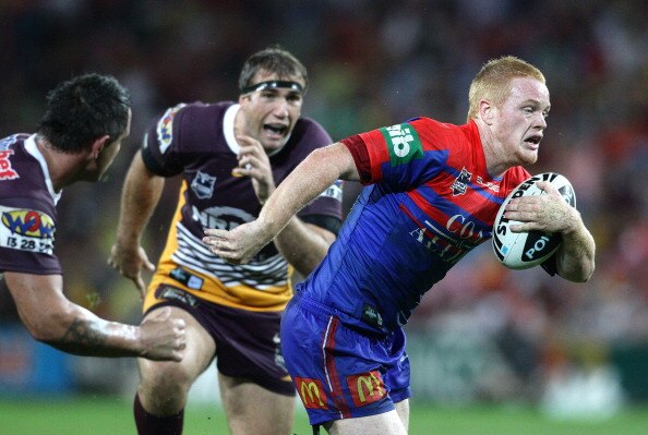 BRISBANE, AUSTRALIA - APRIL 11:  Joel Edwards of the Knights looks to take on the defence during the round five NRL match between the Brisbane Broncos and the Newcastle Knights at Suncorp Stadium on April 11, 2011 in Brisbane, Australia.  (Photo by Bradle
