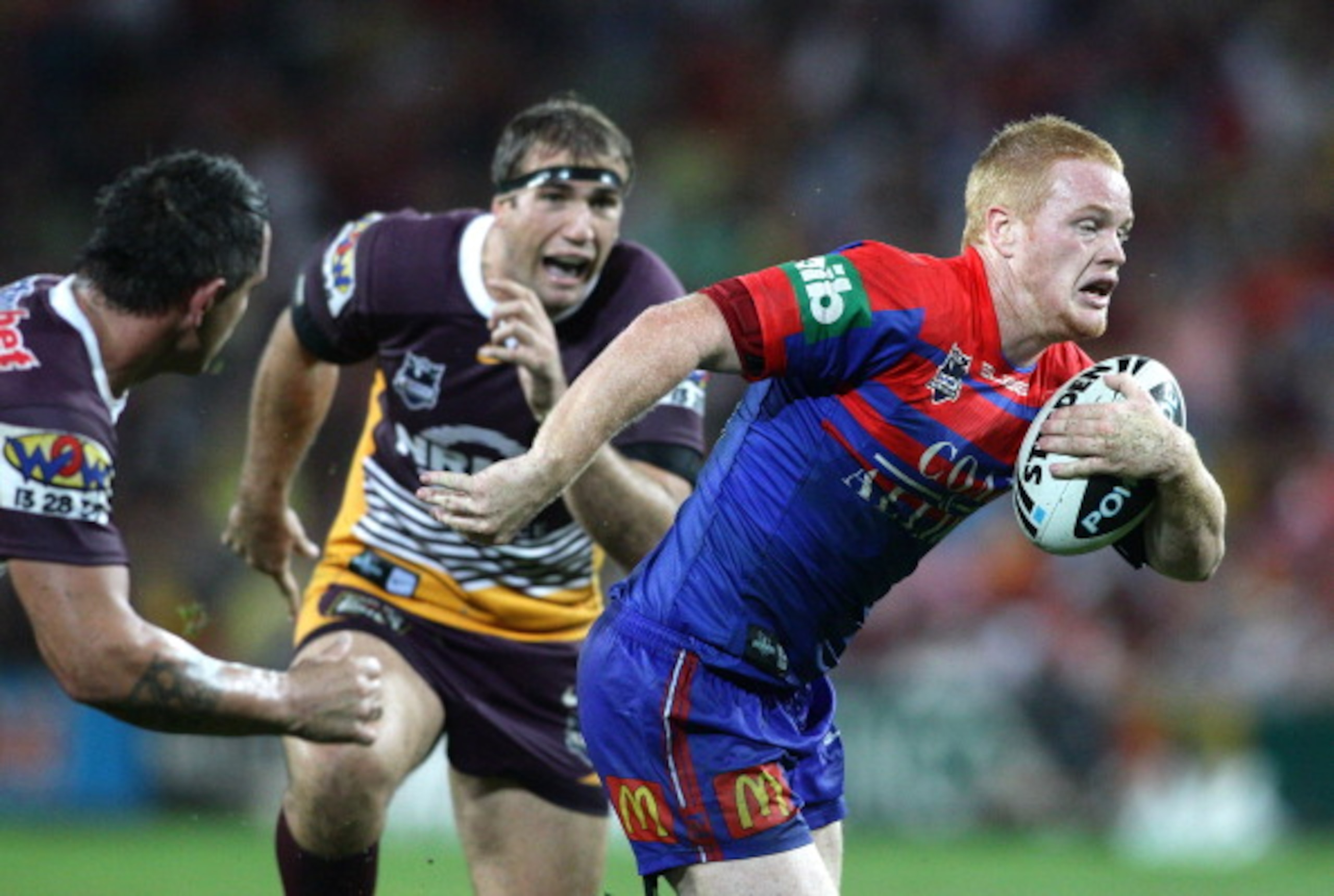 BRISBANE, AUSTRALIA - APRIL 11:  Joel Edwards of the Knights looks to take on the defence during the round five NRL match between the Brisbane Broncos and the Newcastle Knights at Suncorp Stadium on April 11, 2011 in Brisbane, Australia.  (Photo by Bradle