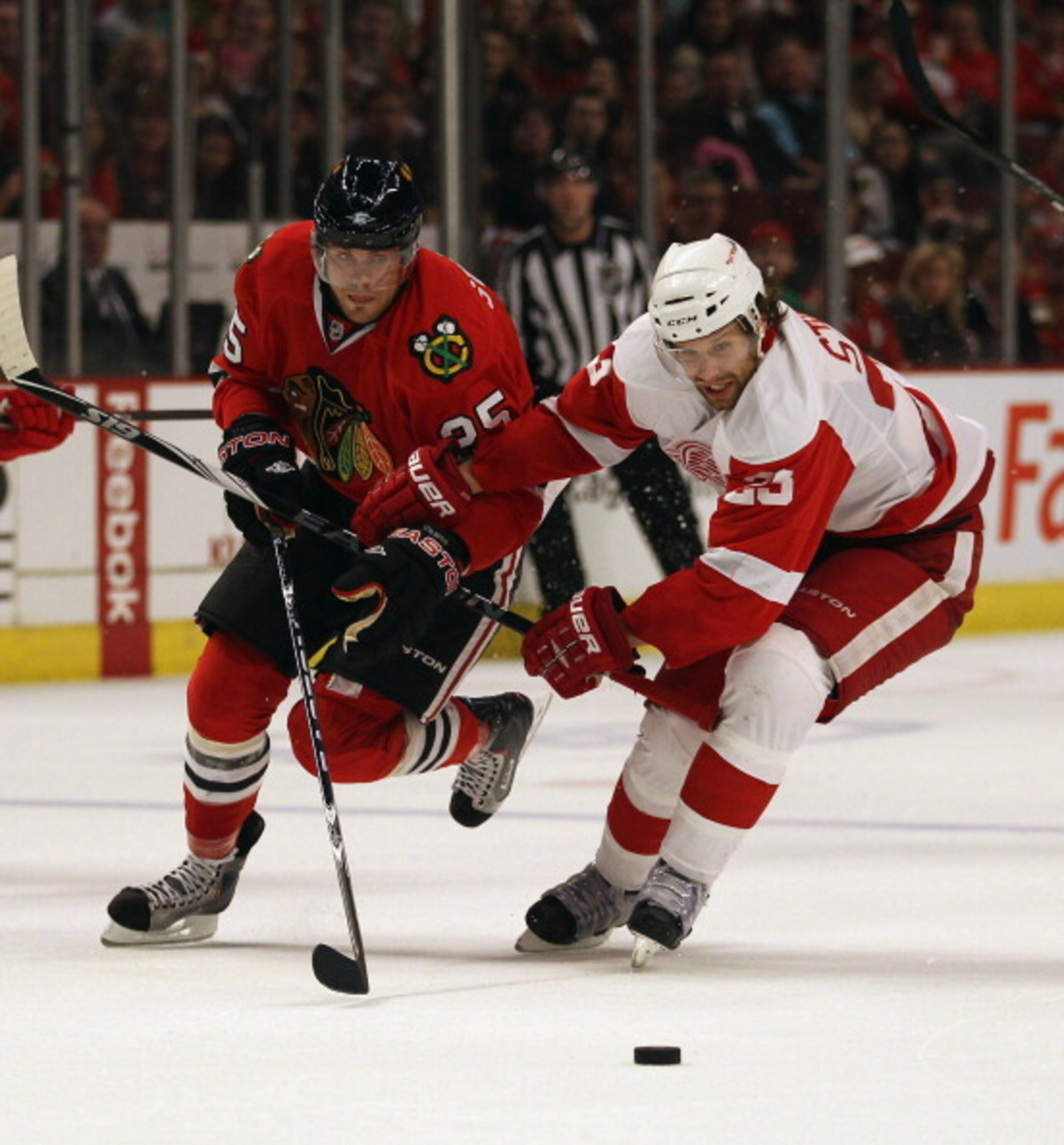 CHICAGO, IL - APRIL 10: Viktor Stalberg #25 of the Chicago Blackhawks battles with Brad Stuart #23 of the Detroit Red Wings at the United Center on April 10, 2011 in Chicago, Illinois. The Red Wings defeated the Blackhawks 4-3. (Photo by Jonathan Daniel/G