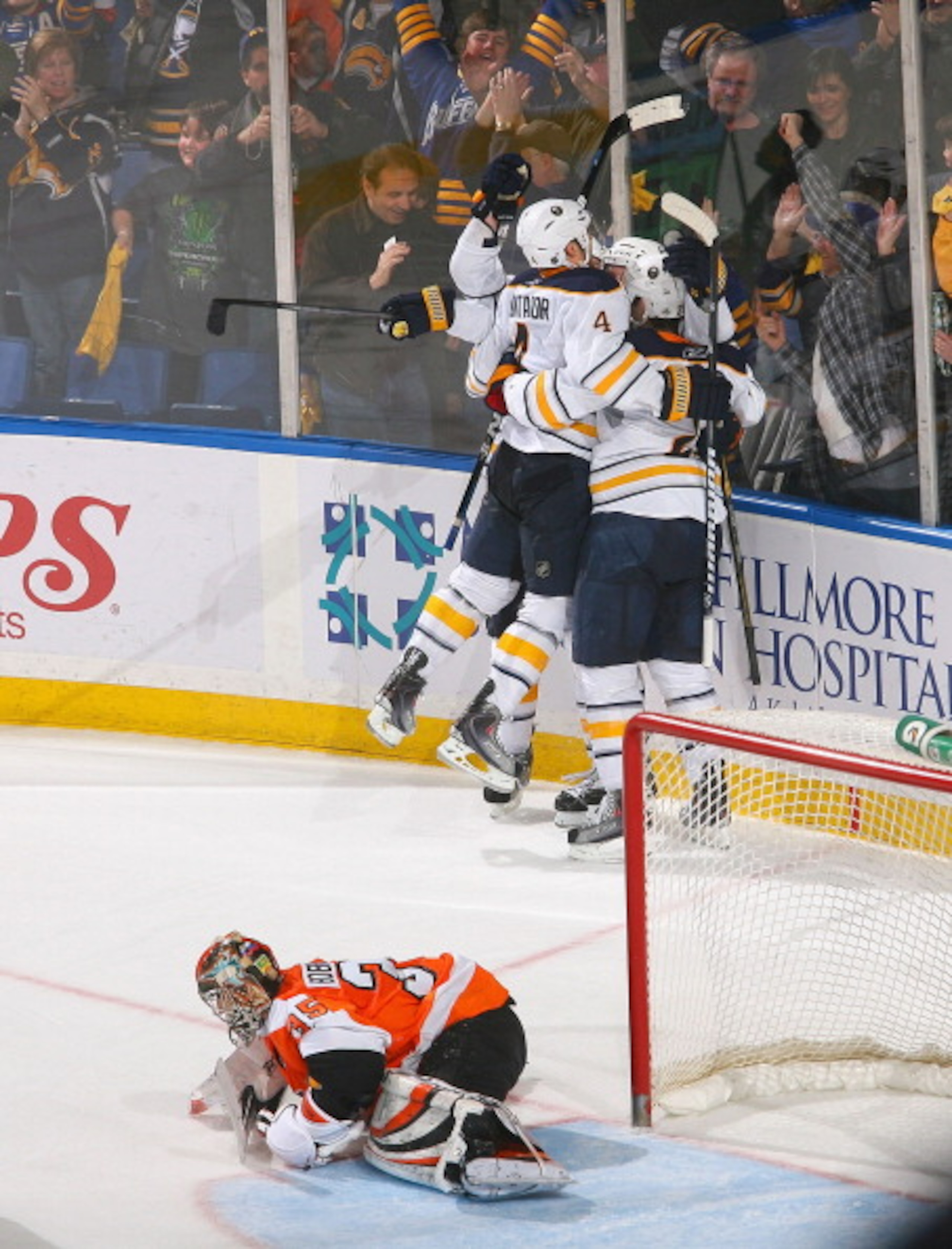 BUFFALO, NY - APRIL 08: Players from the Buffalo Sabres skate to Thomas Vanek #26  after Vanek scored the game winning goal in overtime against Sergei Bobrovsky #35 of the Philadelphia Flyers at HSBC Arena on April 8, 2011 in Buffalo, New York. Buffalo wo