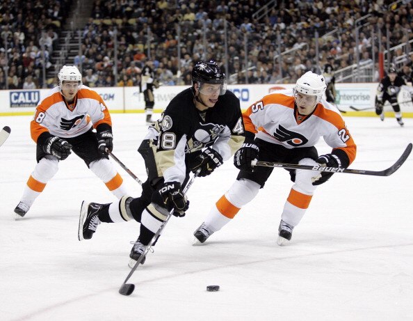 PITTSBURGH, PA - MARCH 29:  Tyler Kennedy #48 of the Pittsburgh Penguins handles the puck in front of Matt Carle #25 and Danny Briere #48 of the Philadelphia Flyers at Consol Energy Center on March 29, 2011 in Pittsburgh, Pennsylvania.  (Photo by Justin K