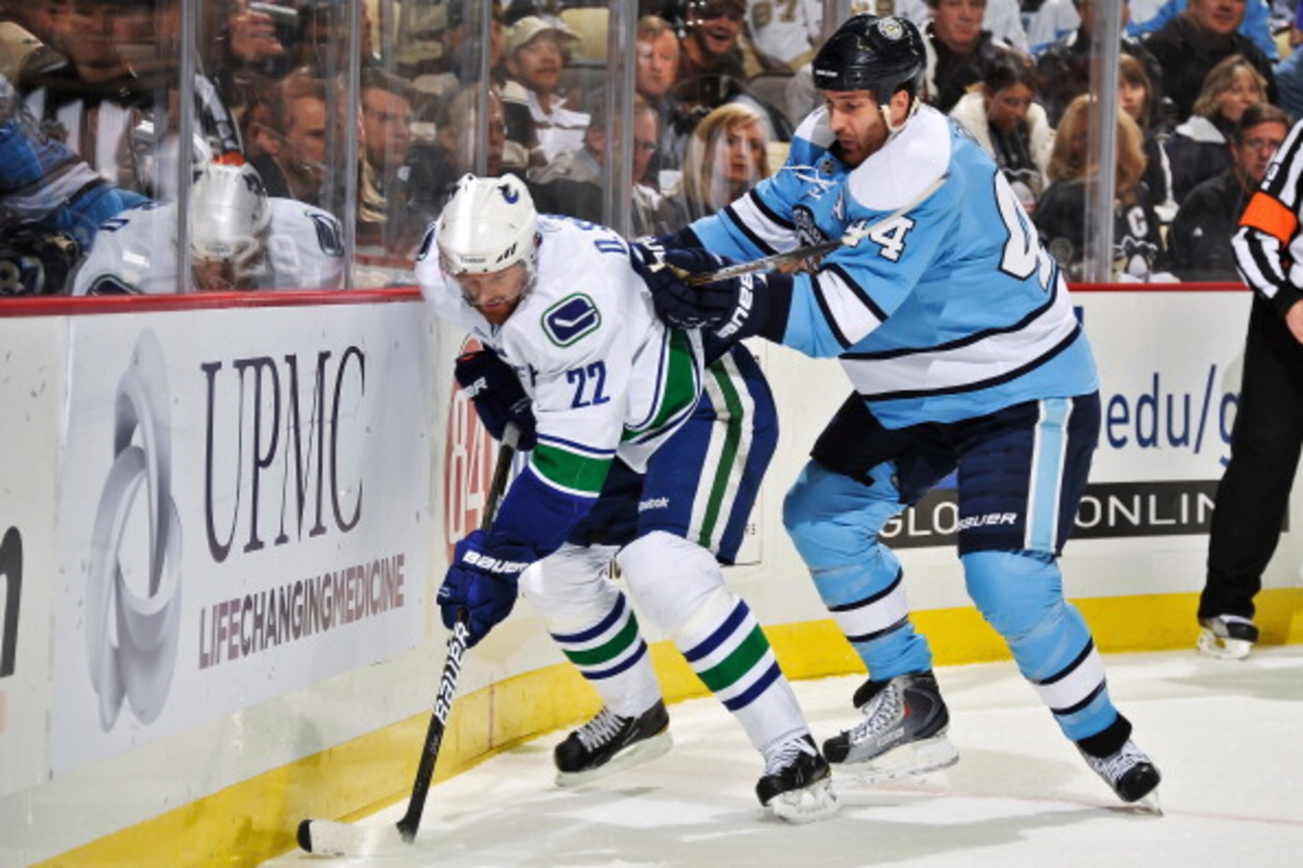 PITTSBURGH - NOVEMBER 17: Brooks Orpik #44 of the Pittsburgh Penguins attempts to check Daniel Sedin #22 of the Vancouver Canucks off the puck on November 17, 2010 at Consol Energy Center in Pittsburgh, Pennsylvania. (Photo by Jamie Sabau/Getty Images) PITTSBURGH - NOVEMBER 17: Brooks Orpik #44 of the Pittsburgh Penguins attempts to check Daniel Sedin #22 of the Vancouver Canucks off the puck on November 17, 2010 at Consol Energy Center in Pittsburgh, Pennsylvania. (Photo by Jamie Sabau/Getty Images)