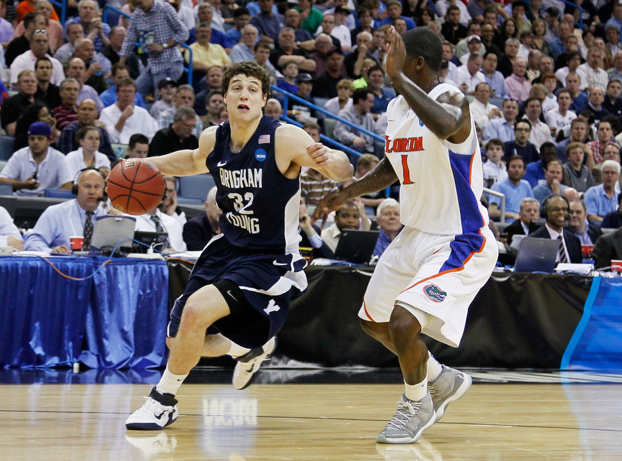 NEW ORLEANS, LA - MARCH 24:  Jimmer Fredette #32 of the Brigham Young Cougars drives past Kenny Boynton #1 of the Florida Gators during the Southeast regional of the 2011 NCAA men's basketball tournament at New Orleans Arena on March 24, 2011 in New Orlea